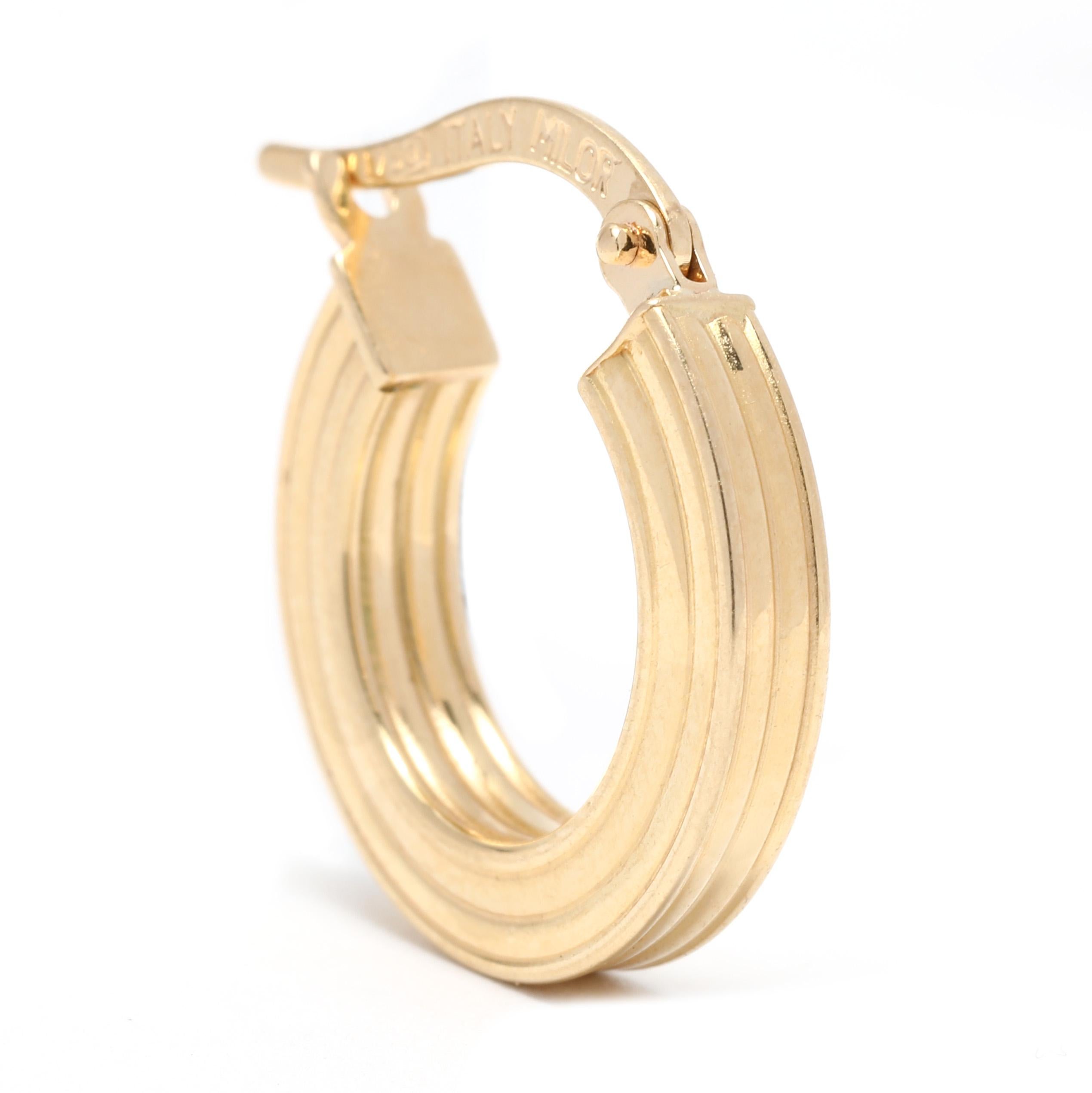 These Italian Milor Ridge Gold Huggie Hoop Earrings add a modern edge to your everyday jewelry. Crafted from 18K yellow gold and measuring 5/8 inch in length, these small gold hoops are perfect for everyday wear. Add a touch of contemporary glam to