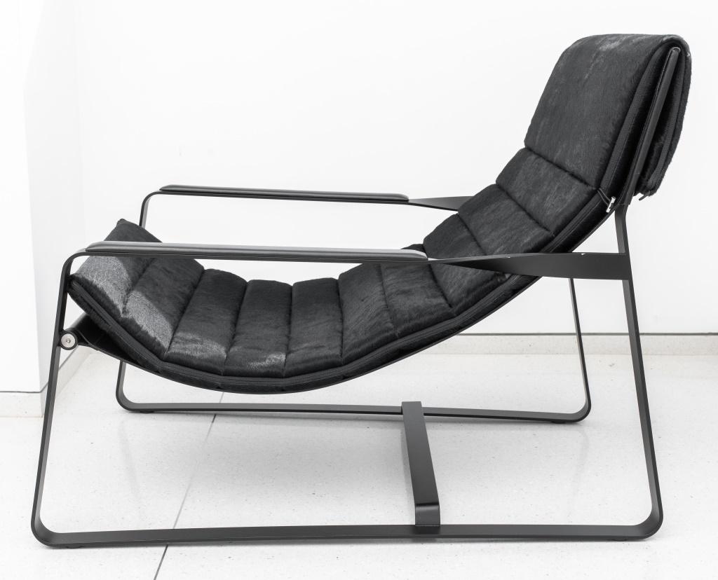 Italian black mohair lounge chair, designed by Minotti, with a black steel frame, twisted handles with leather pads, and a black mohair upholstered cushion resting on a black leather pad, made in Italy, marked. 30.5
