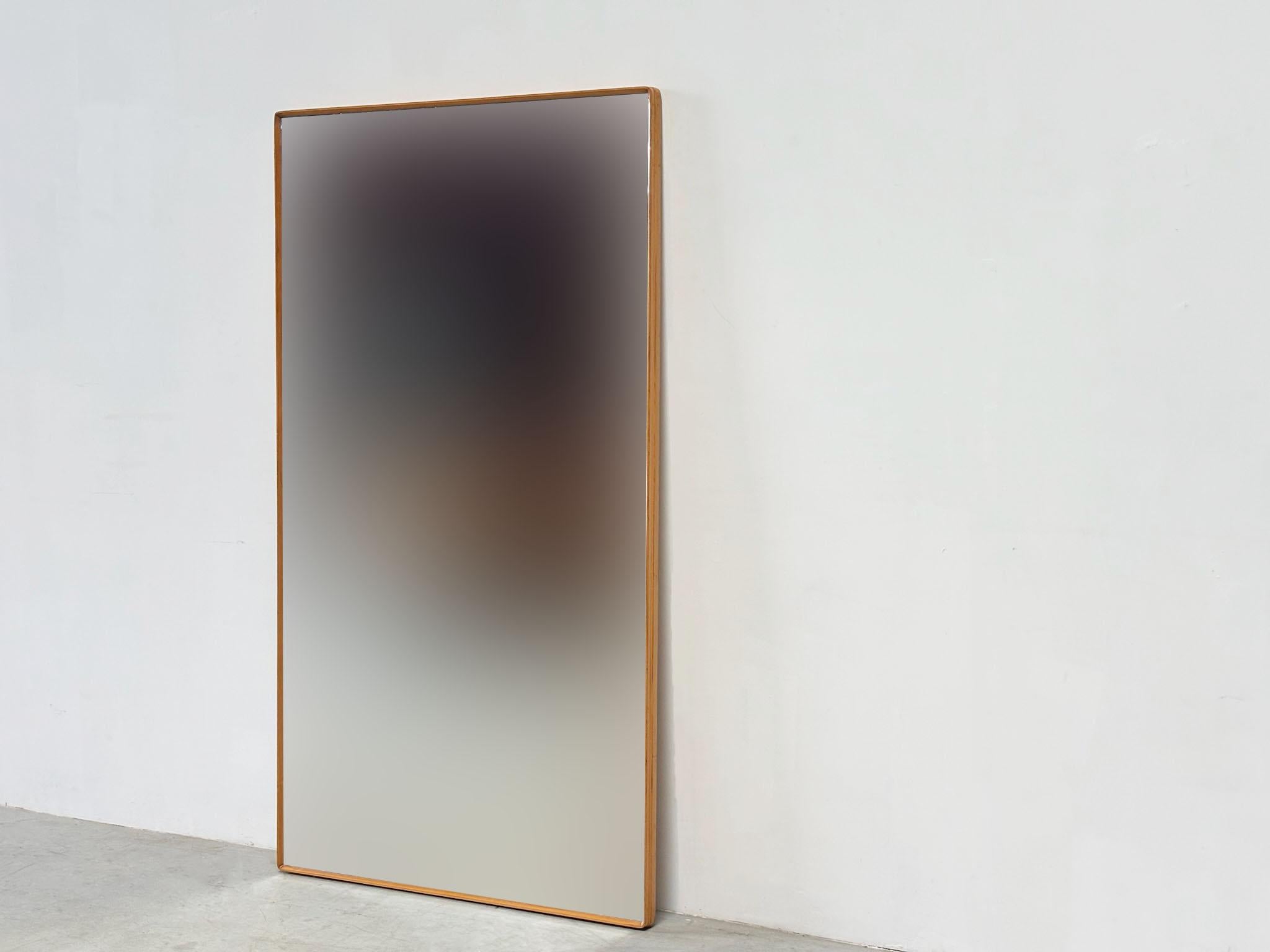 This XL wall mirror from the 1960s was designed in Italy by the designer Silvio Cavatorta, best known for his elegant sideboards and bedside tables, but who also created distinctive standalone mirrors.
It features a refined maple wood frame and