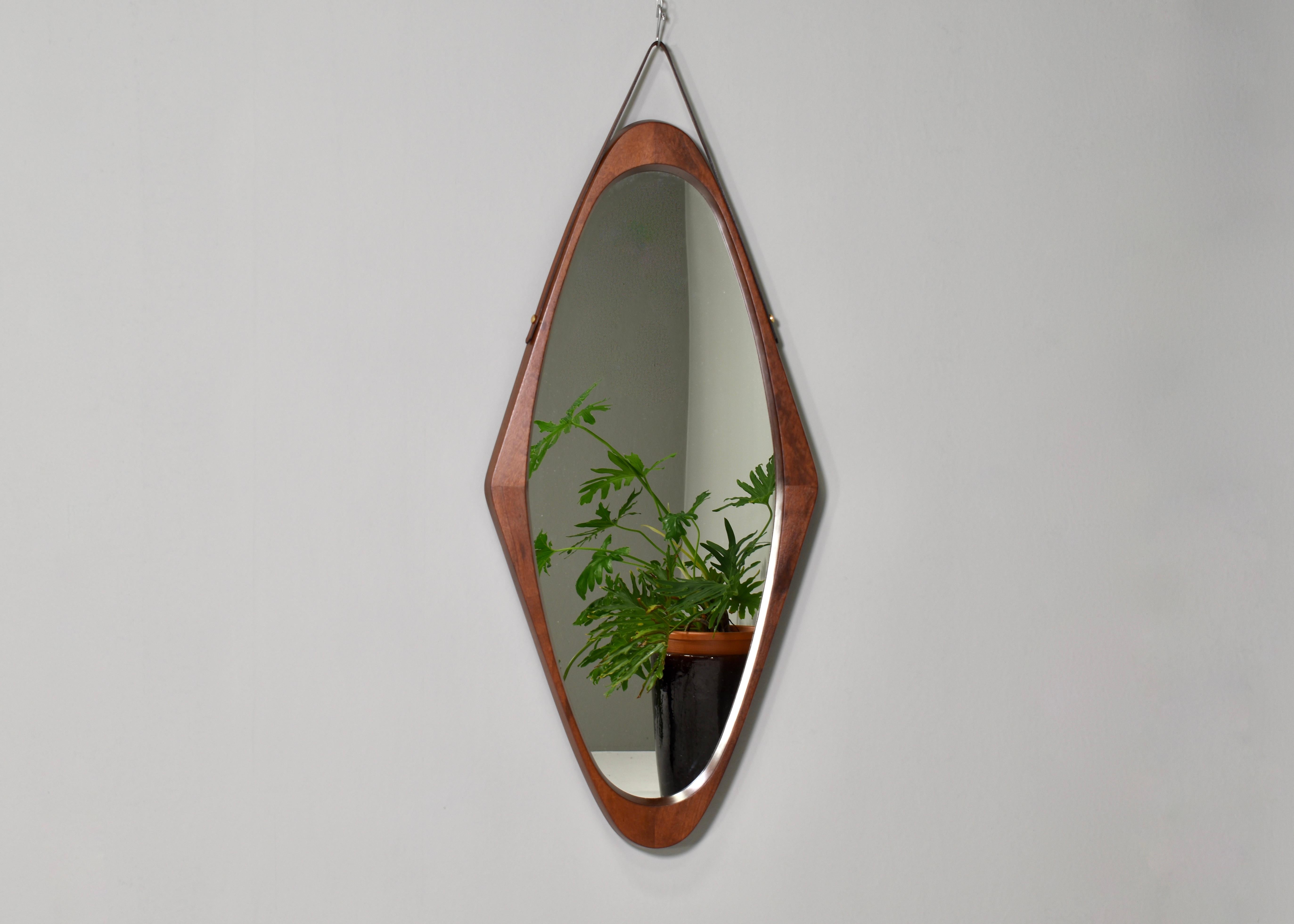 Elegant 1950’s mirror in solid teak. It features a leather strap and brass details. In excellent condition.
Designer: Unknown
Manufacturer: Unknown
Country: Italy
Model: Wall mirror
Design period: 1950’s
Date of manufacturing: circa 1950
Size wdh in