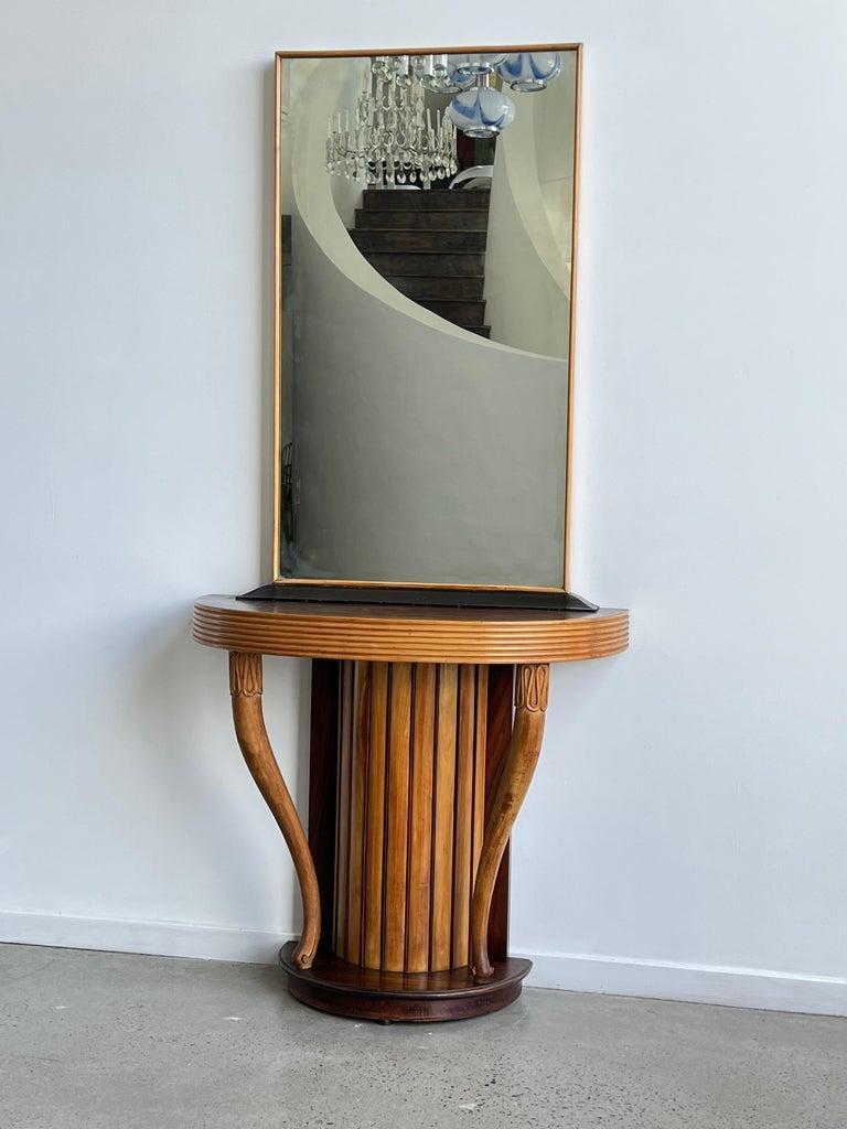 Striking Osvaldo Borsani hand curved wood console with mirror. 

Osvaldo Borsani was an Italian designer who was active in the mid-20th century. He is known for his innovative furniture designs that often incorporated new materials and