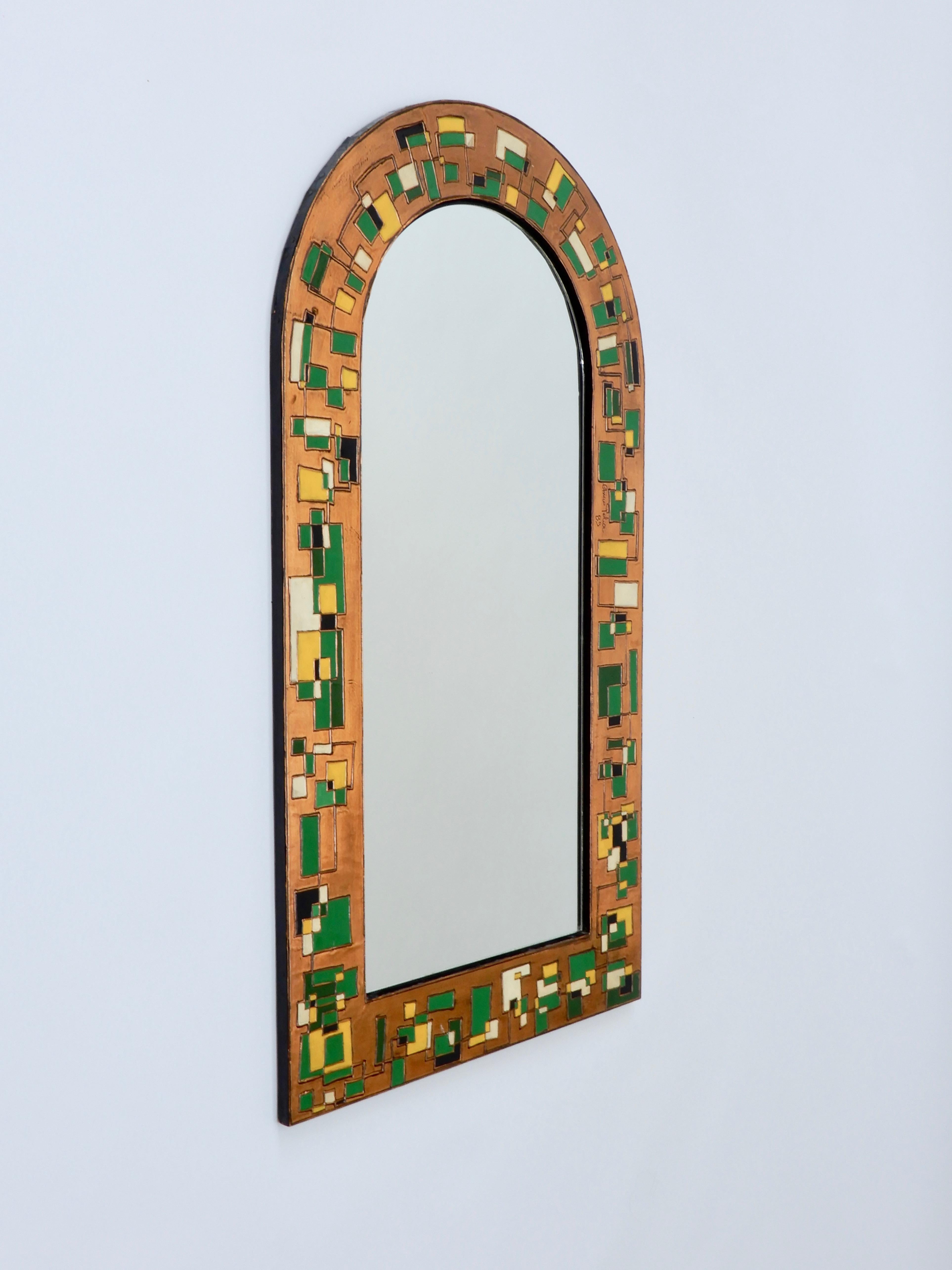 Italian mirror with a coloured copper repoussé sheet frame. Dated 1989.