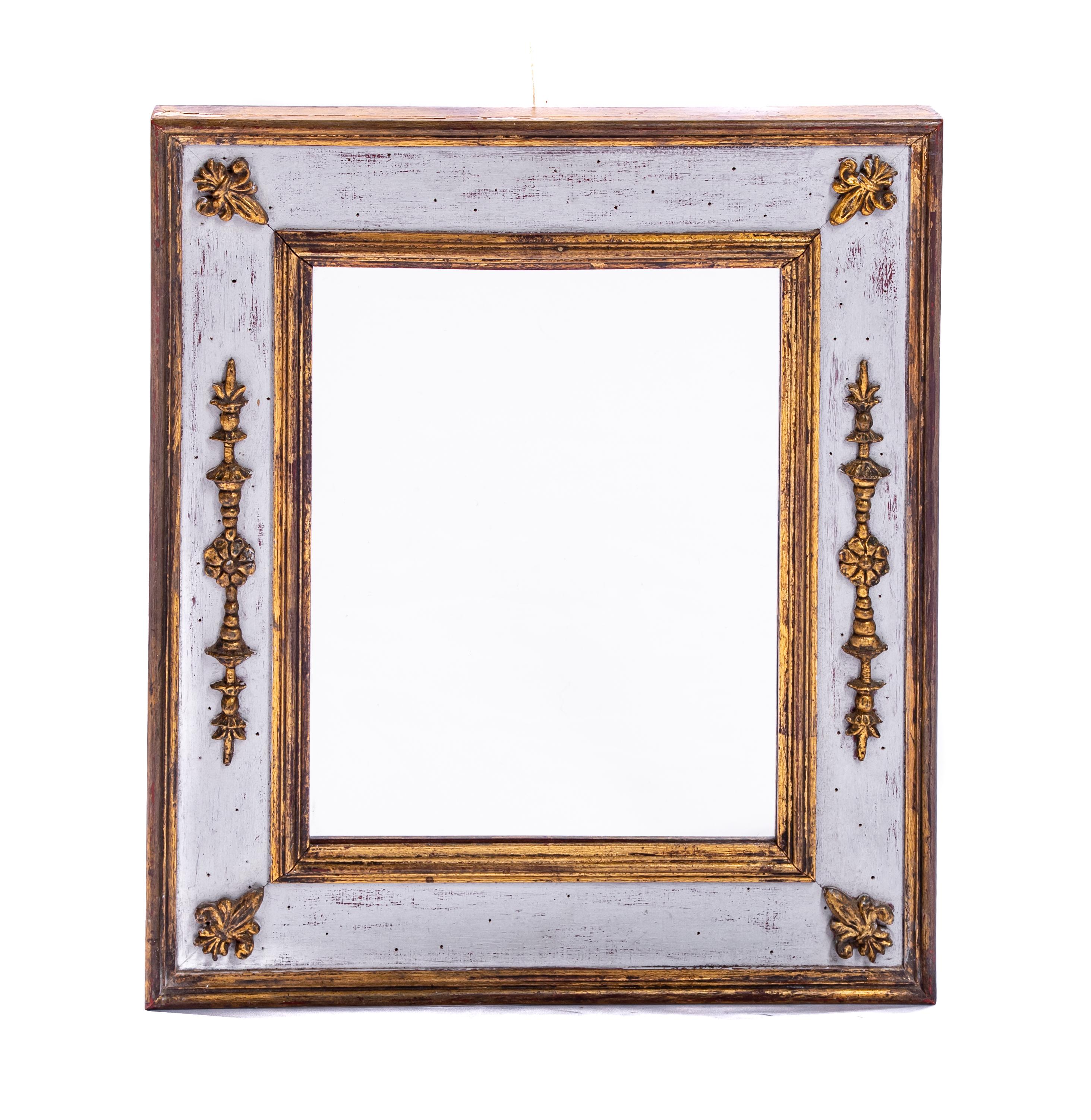 Offering this beautiful Italian mirror with gilded accents. It is a simple design with four gilded fleur-de-lis in each corner. On each side is gilded scrollwork with foliate and floral detail. The outside edge of the frame and inner frame are