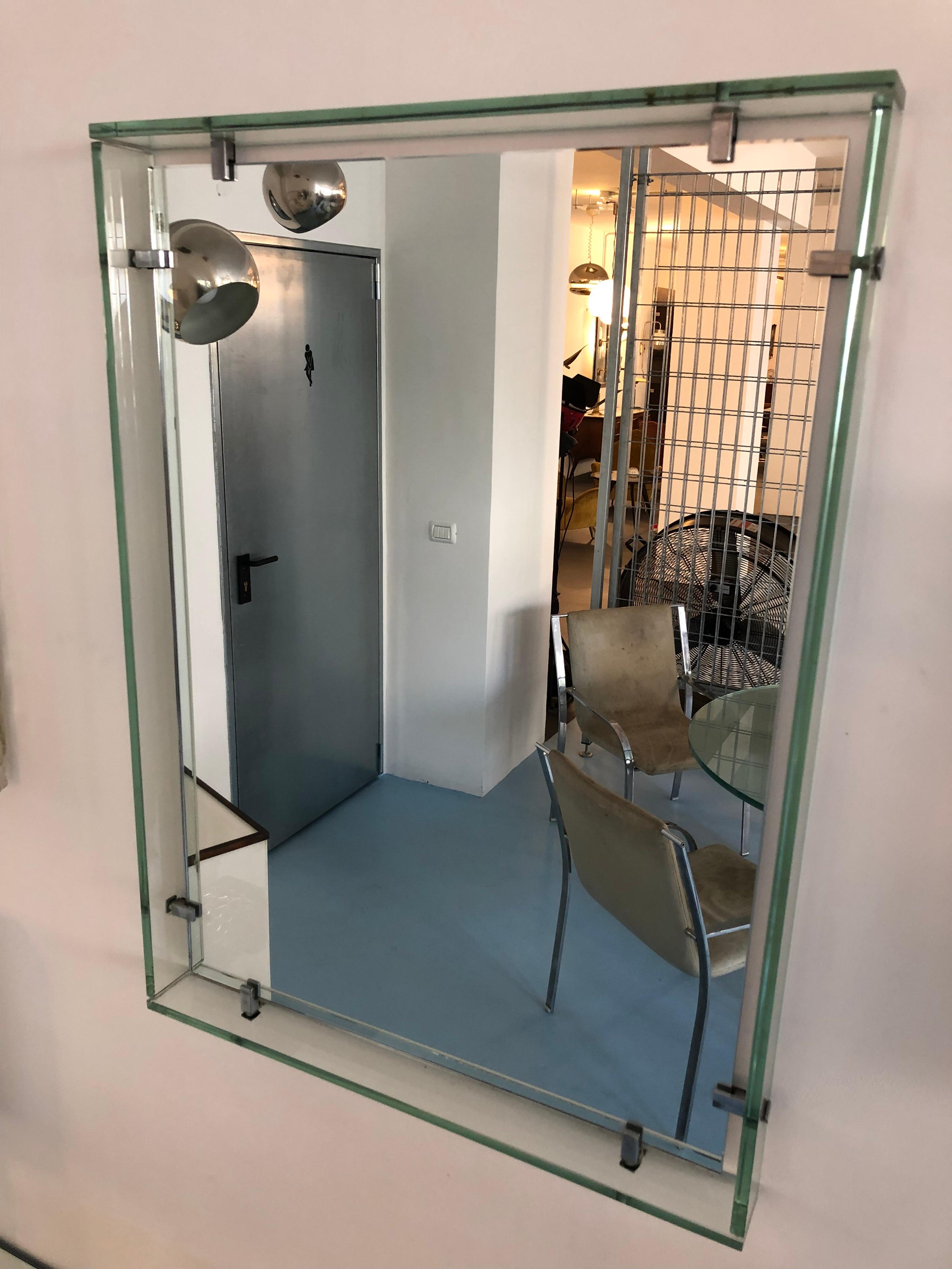 This mirror was produced in Italy by Fontana Arte in the 1961. It is made from thick clear glass and mirror. Very good vintage conditions with no cracks or chips.