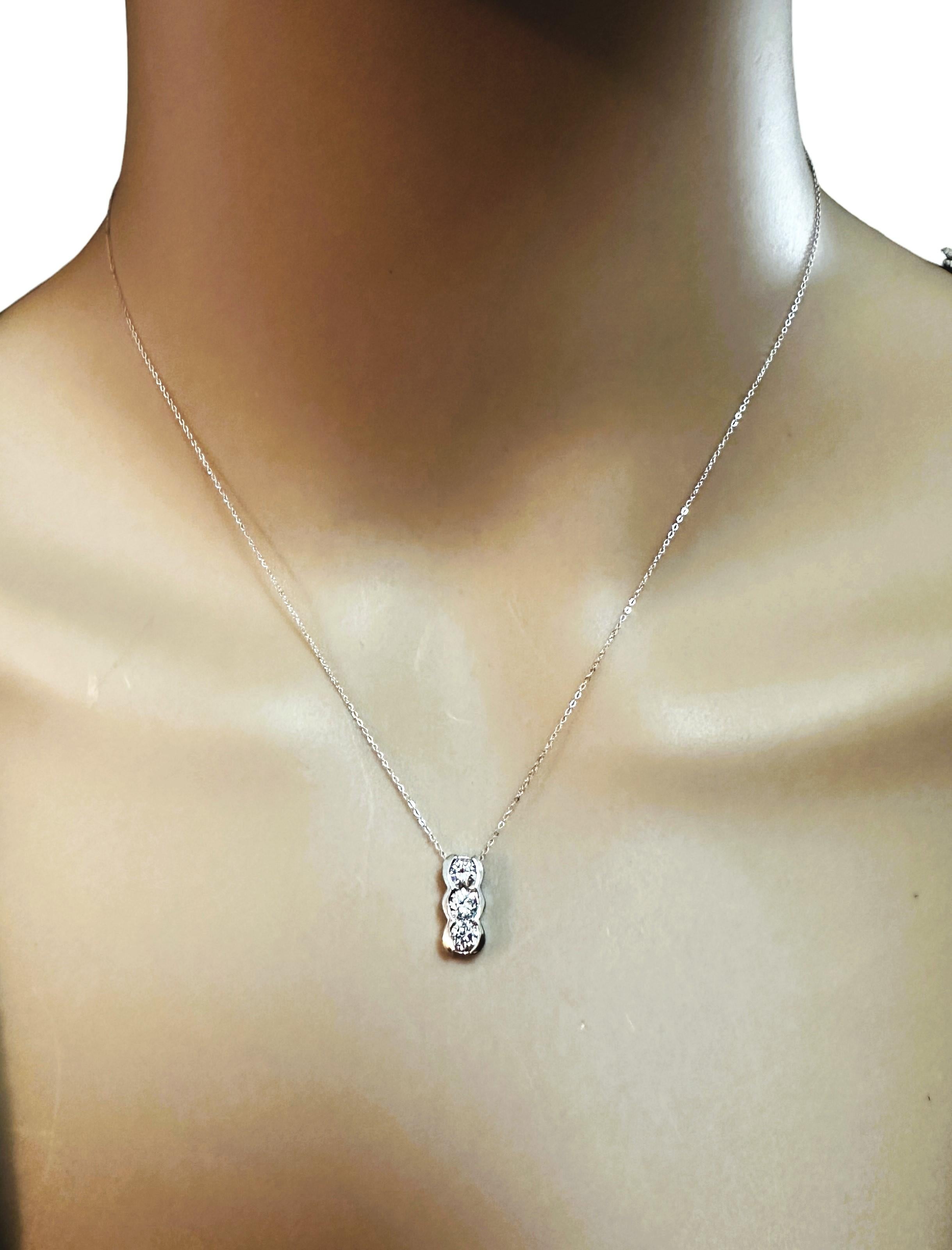 I just love this necklace!  It's just a simple and elegant design and can be worn for any occasion.   It has 3 brilliant cut diamonds measuring  3.5 x 3.5 x 2.16 mm. The Clarity is SI1 and the Color is H.  They total .5 carats.  The necklace is 16