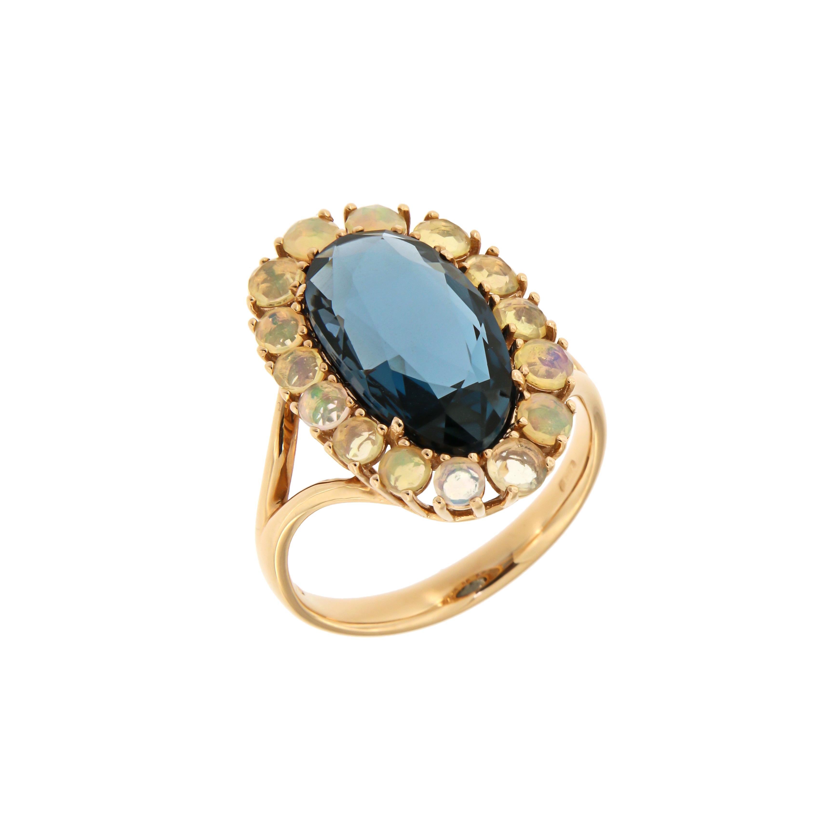 Ring Rose Gold 18 K
London blue topaz 4,79ct
Opal 

Weight 5 grams
Different Sizes Available

With a heritage of ancient fine Swiss jewelry traditions, NATKINA is a Geneva based jewellery brand, which creates modern jewellery masterpieces suitable