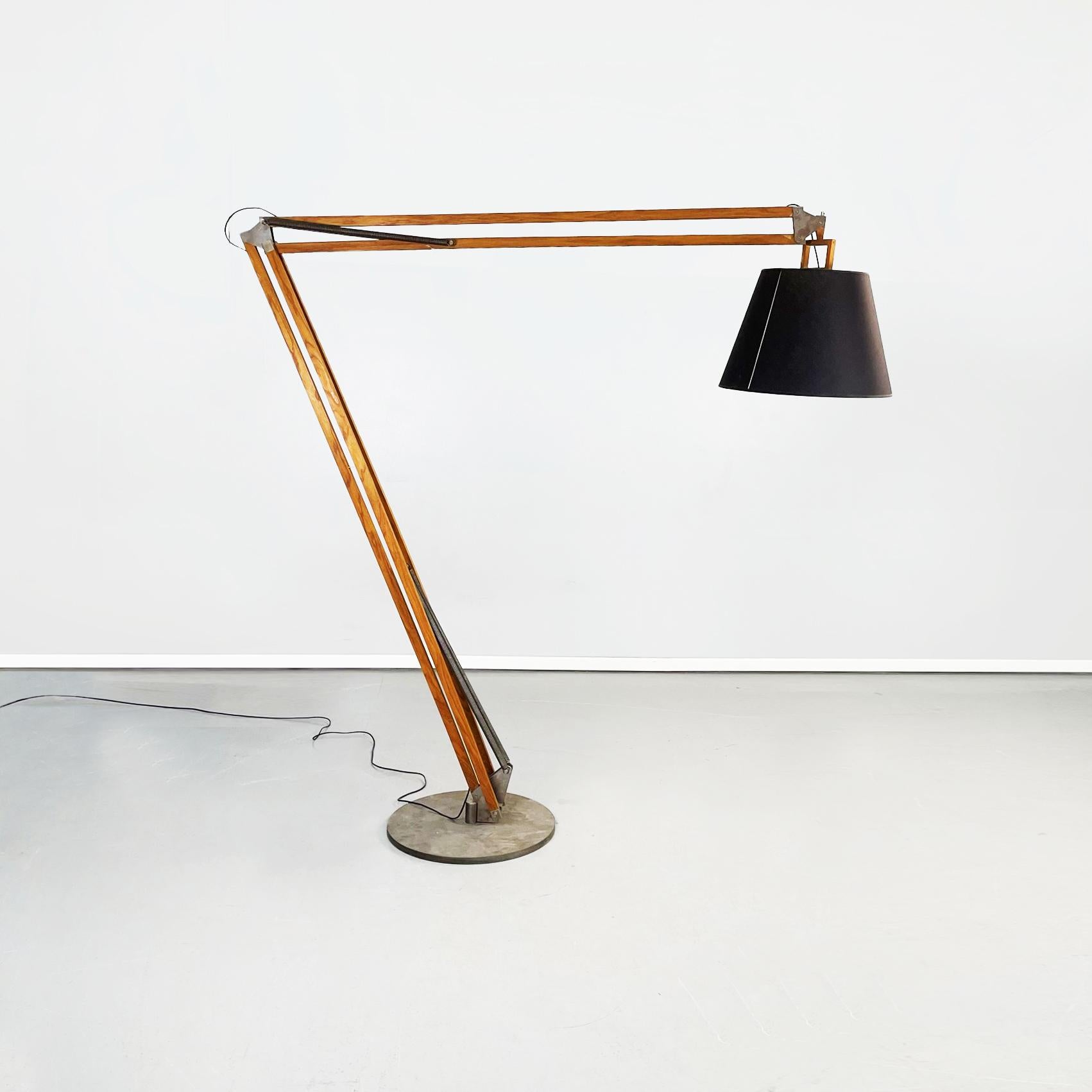 Italian Modern 21th century wooden and iron floor lamp Golia, 2000s
Floor lamp mod. Golia with round iron base and wooden structure. The structure consists of 2 arms with a pantograph system that allows you to maintain the desired positions. The