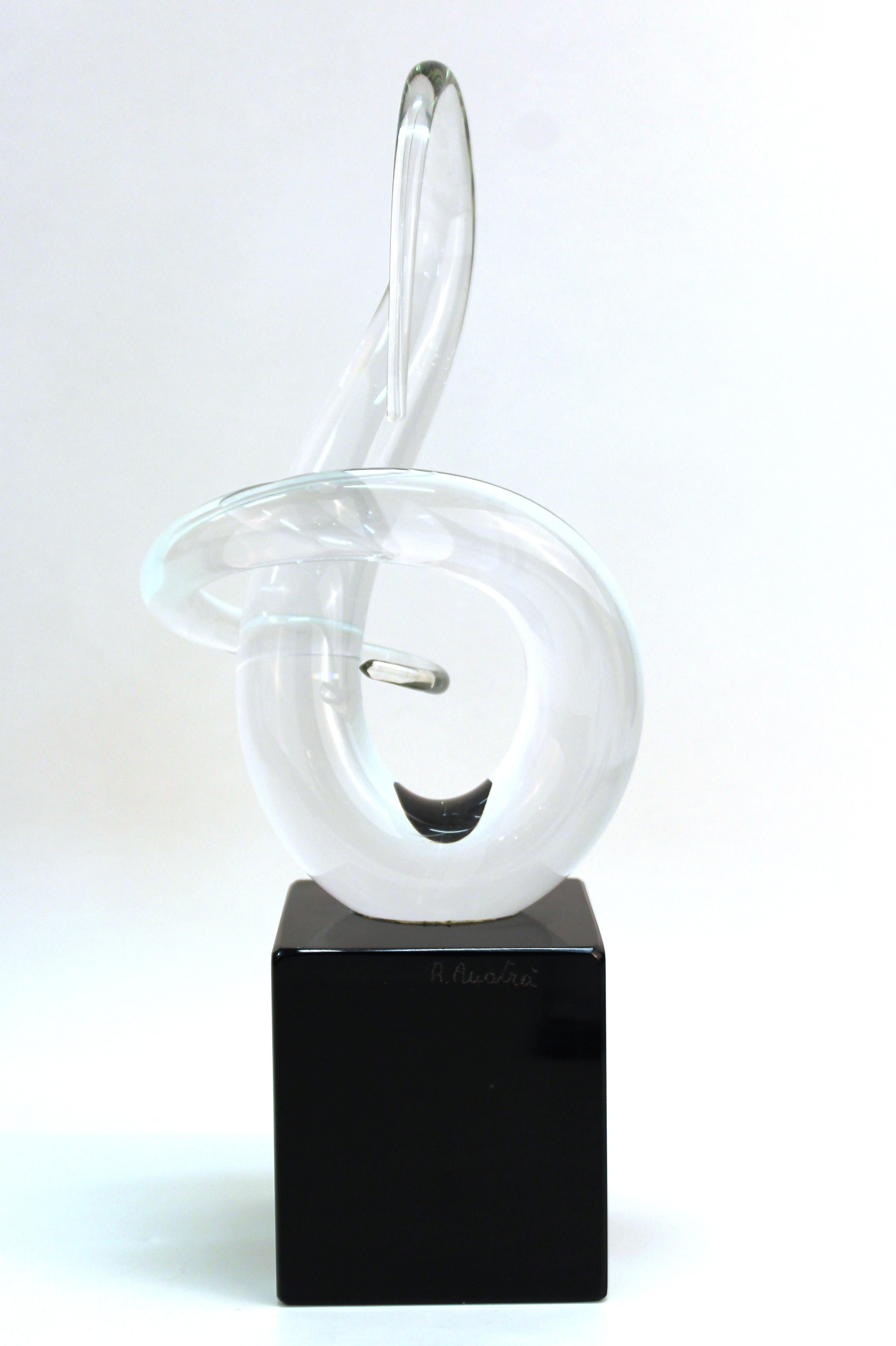 Italian Modern abstract art glass tabletop sculpture in clear glass atop a black base. The piece is signed 'R. Auotra' and dates from the 1980s. In great vintage condition with age-appropriate wear and use.