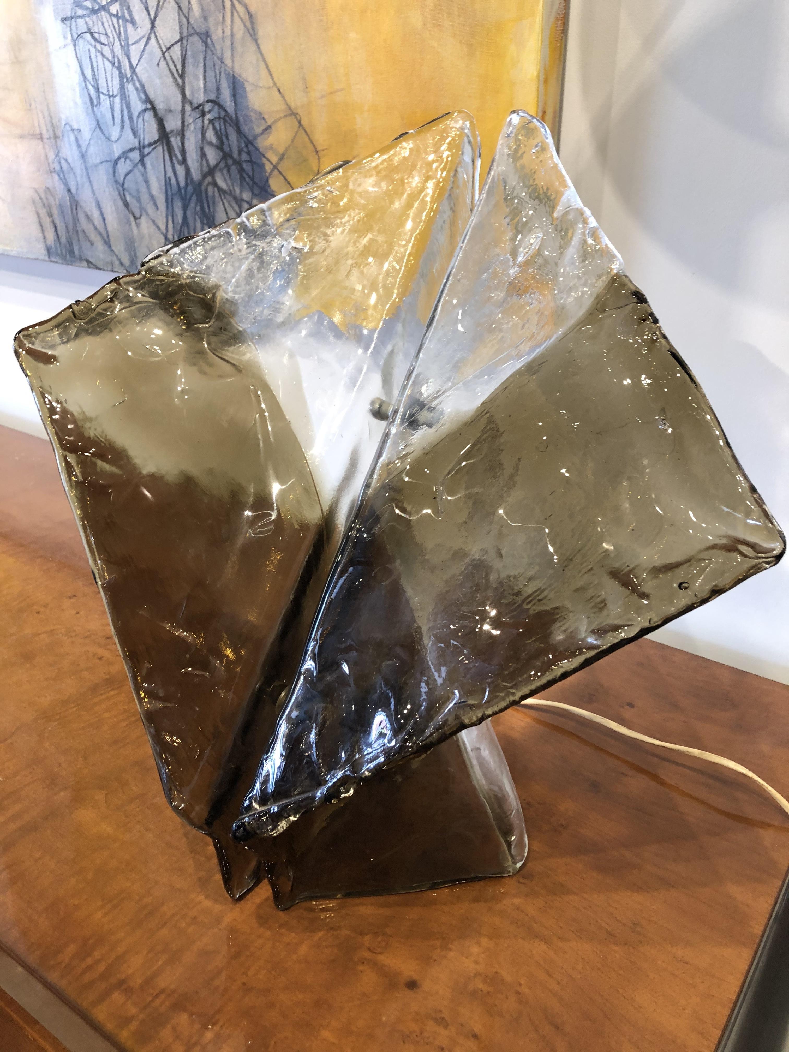 An abstract shaped Italian glass art lamp. This table lamp has been internally rewired for the American Market. 
This lamp is very sculptural, and even when not lit, looks like a beautiful glass sculpture.