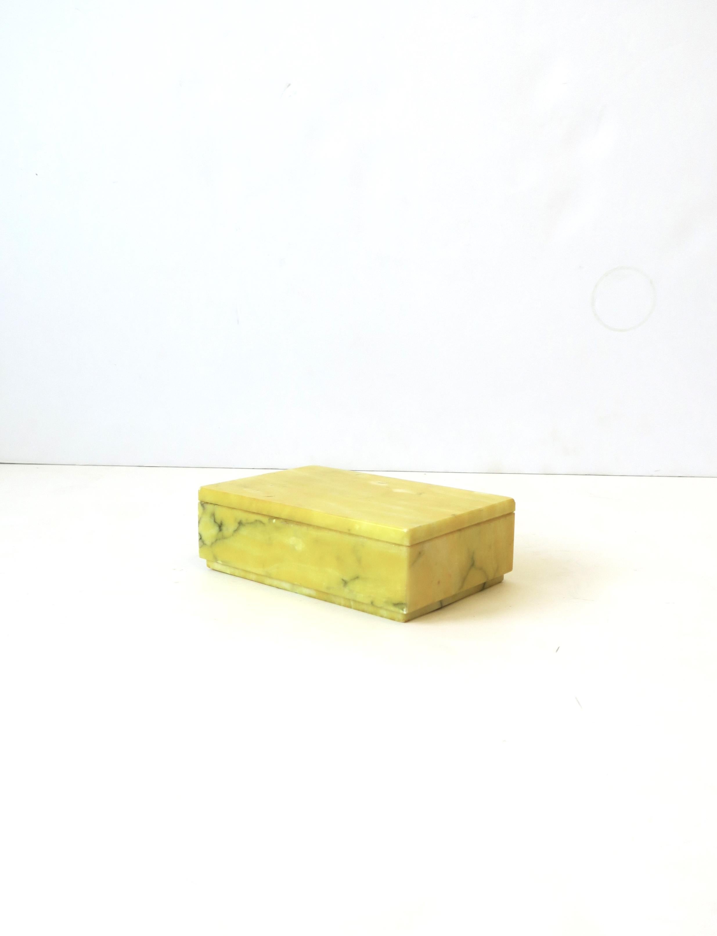 An Italian '70s modern bright yellow alabaster marble jewelry box, circa 1970s, Italy. Beautiful as a standalone piece, for jewelry (as demonstrated), or other small items on a nightstand table, vanity, console, desk, walk-in-closet, etc. Box is