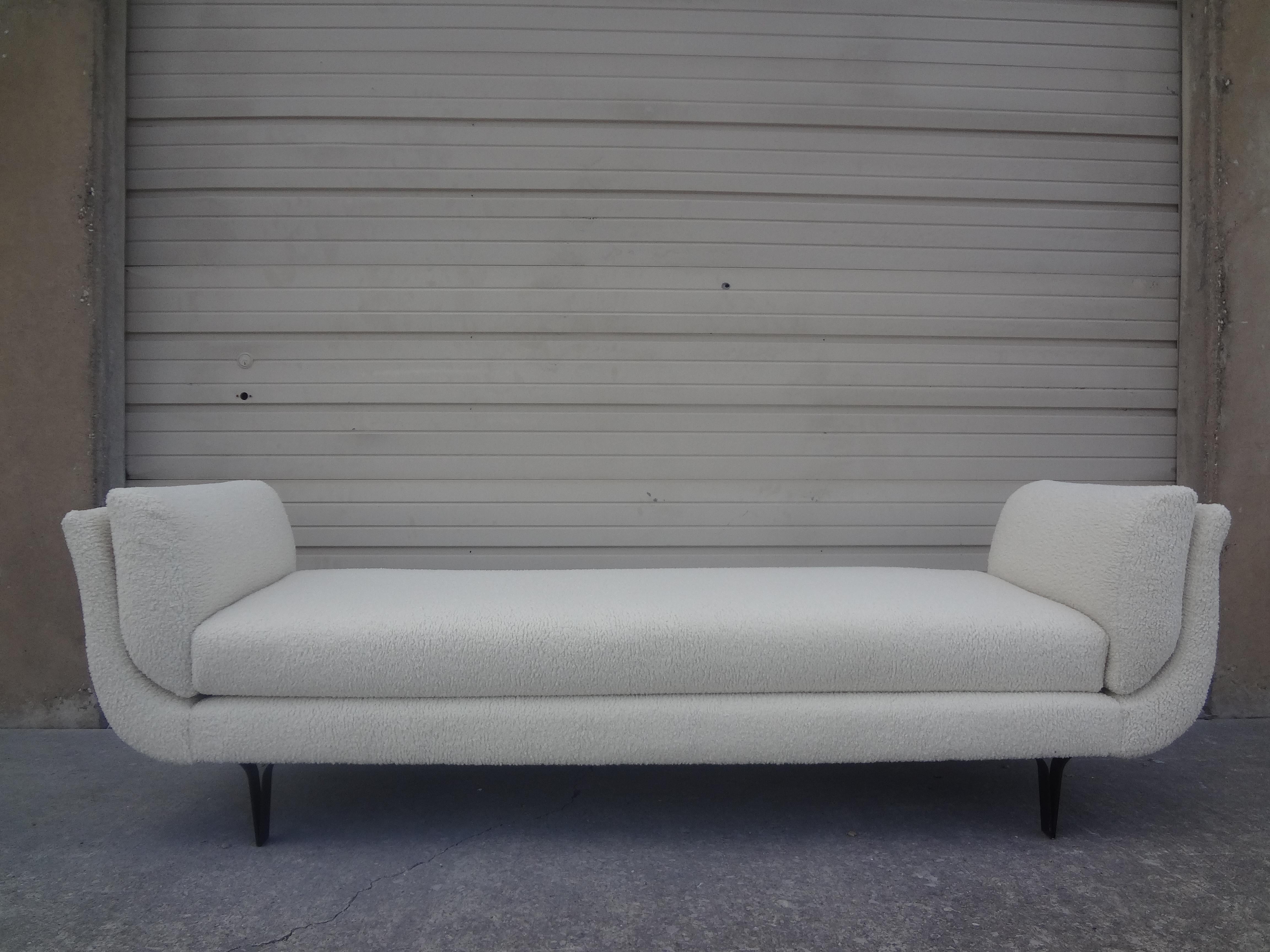 Italian Modern daybed or bench attributed to Osvaldo Borsani. This shapely long Italian bench, daybed or chaise has interesting iron legs and has been professionally upholstered in plush cream boucle that is both sculptural and stunning. Our Italian