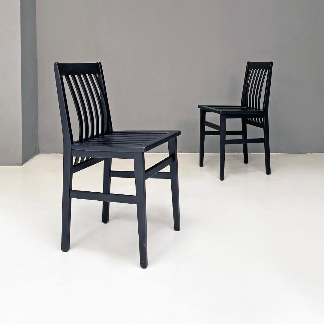 Italian modern matt black lacquered wood set of eight Milano chairs by Aldo Rossi for Molteni, 1987.
Set of eight Milano model chairs, with structure in matt black lacquered wood, square shape, with back and seat with curved parallel slats. Not
