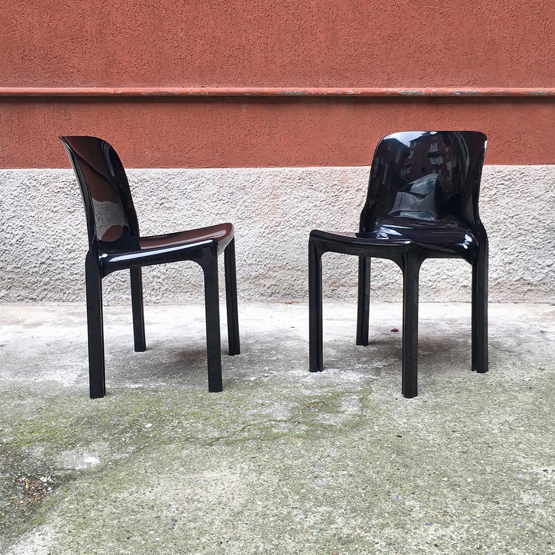 Italian modern black plastic chairs Selene by V. Magistretti for Artemide, 1960s
Pair of black plastic chairs Selene, plastic monocoque structure with grooves along the legs that allow them to be stacked. 
Designed by Vico Magistretti for
