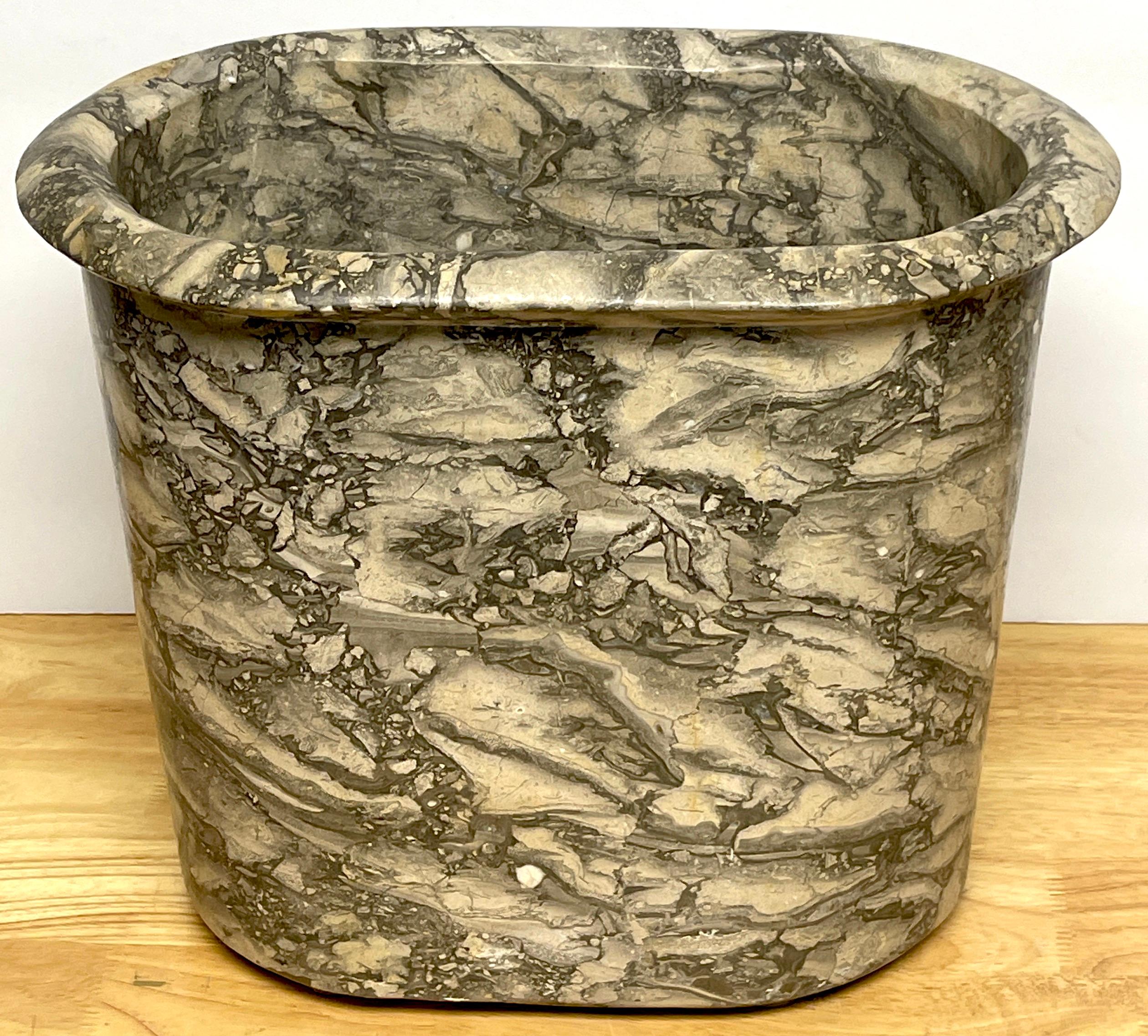 Italian modern black & white variegated marble wastepaper basket/ trash can 
A substantial work, of oval form, with wide conforming carved rim, highlighting the specimen black and white marble pattern, the base measures 11.5