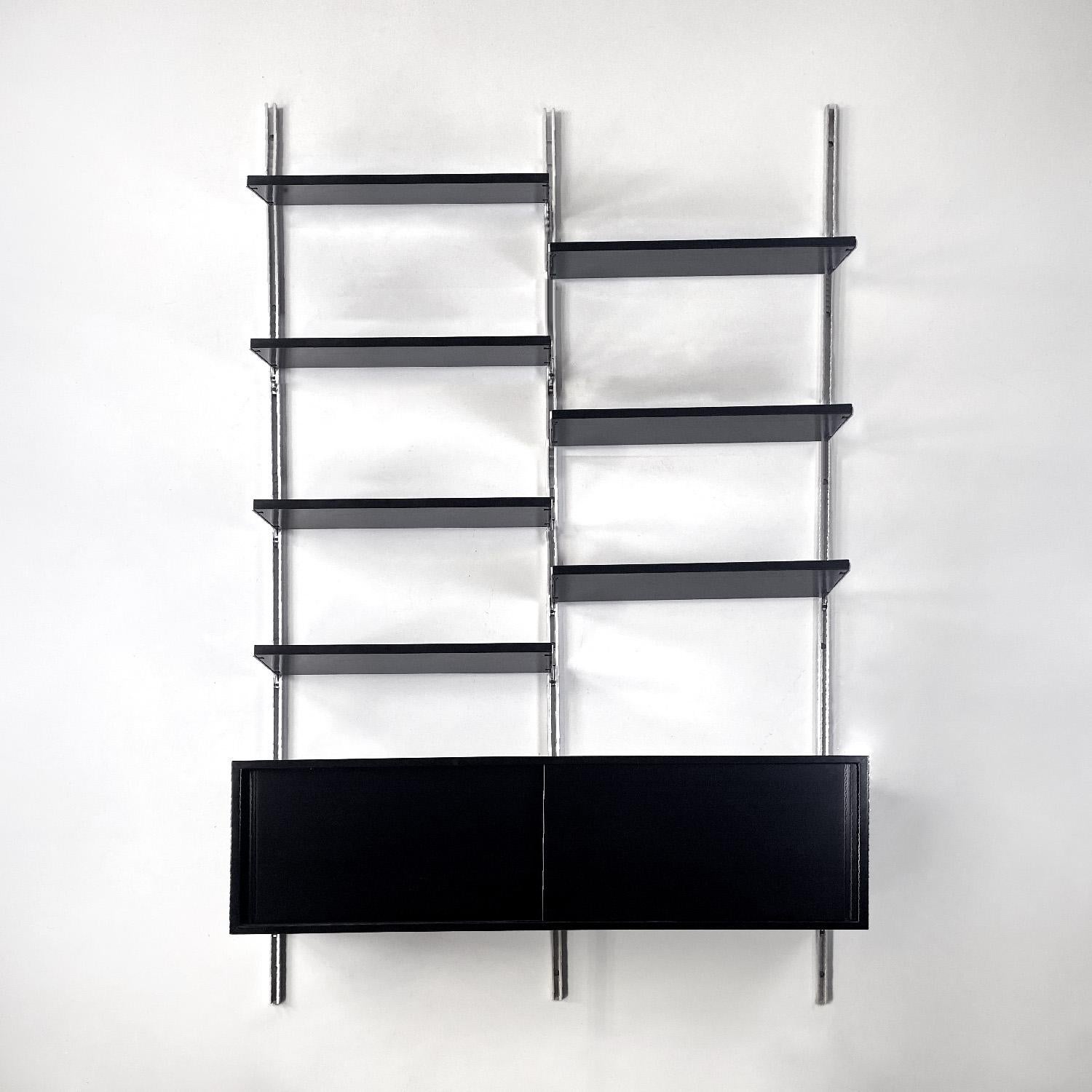 Italian modern black wood and metal bookcase E22 by Borsani for Tecno, 1970s
Wall bookcase mod. E22  in wood and metal. It features three metal uprights, seven black lacquered wooden shelves and a sideboard with sliding doors with internal