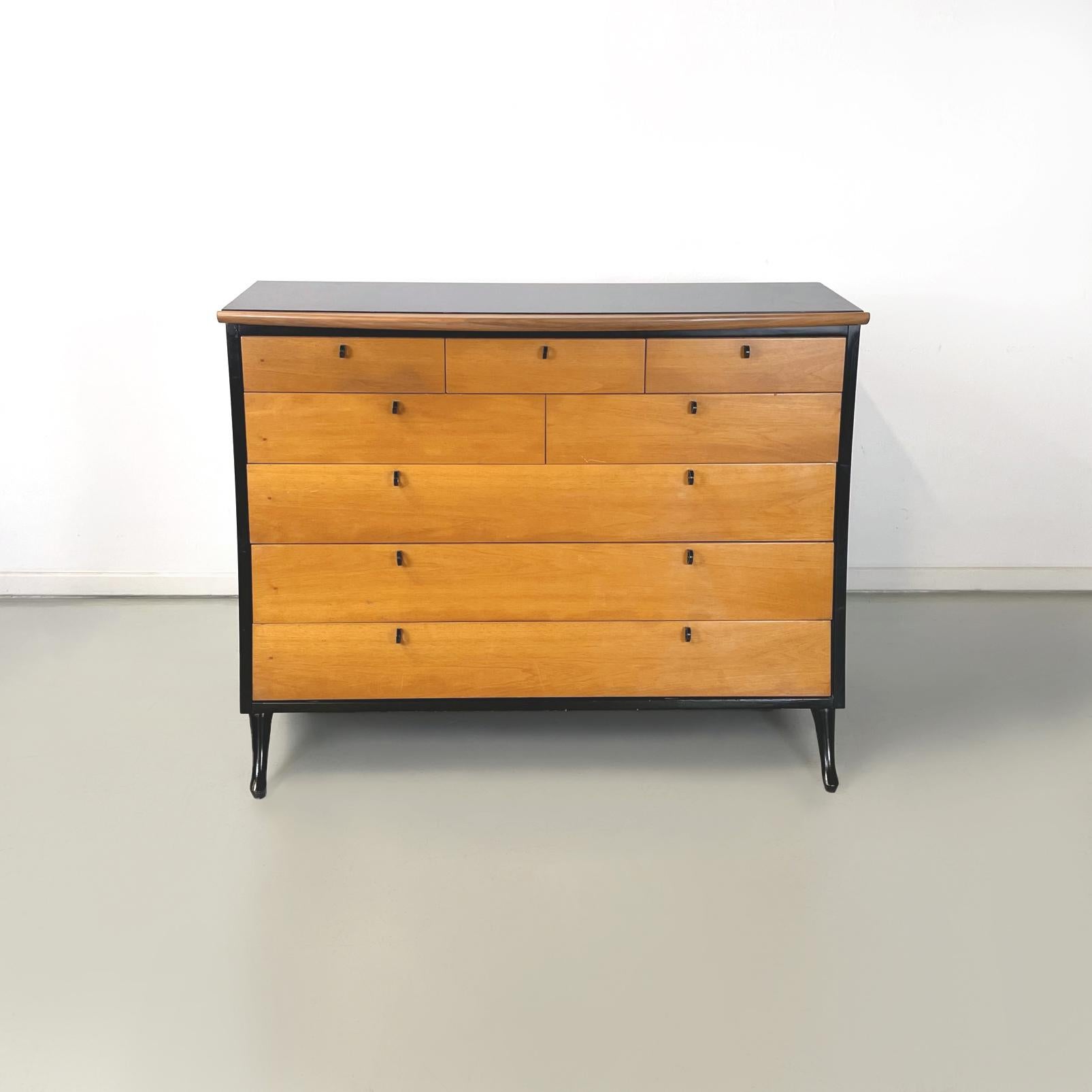 Italian modern black wood Chest of drawers by Umberto Asnago for Giorgetti, 1980s
Cantilever chest of drawers with curved profile and structure in light solid wood and black painted wood. On the front it has 8 drawers of different sizes with ring