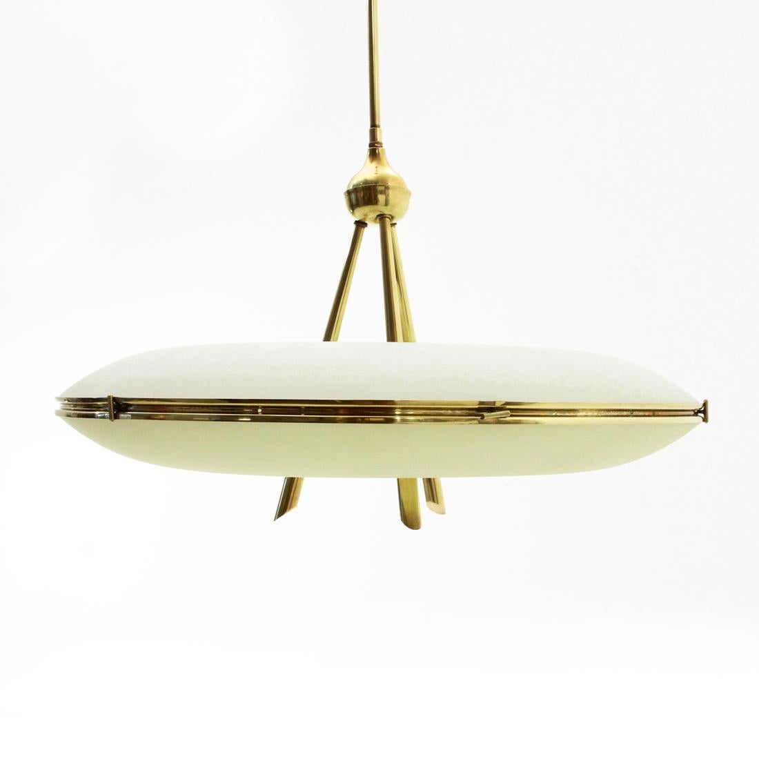 Italian-made chandelier produced in the 1950s.
Rosette, stem and body in brass.
Double sandblasted diffuser in curved white and yellow glass.
Good general condition, some signs due to normal use of time, glass whit chipping where it rests on the