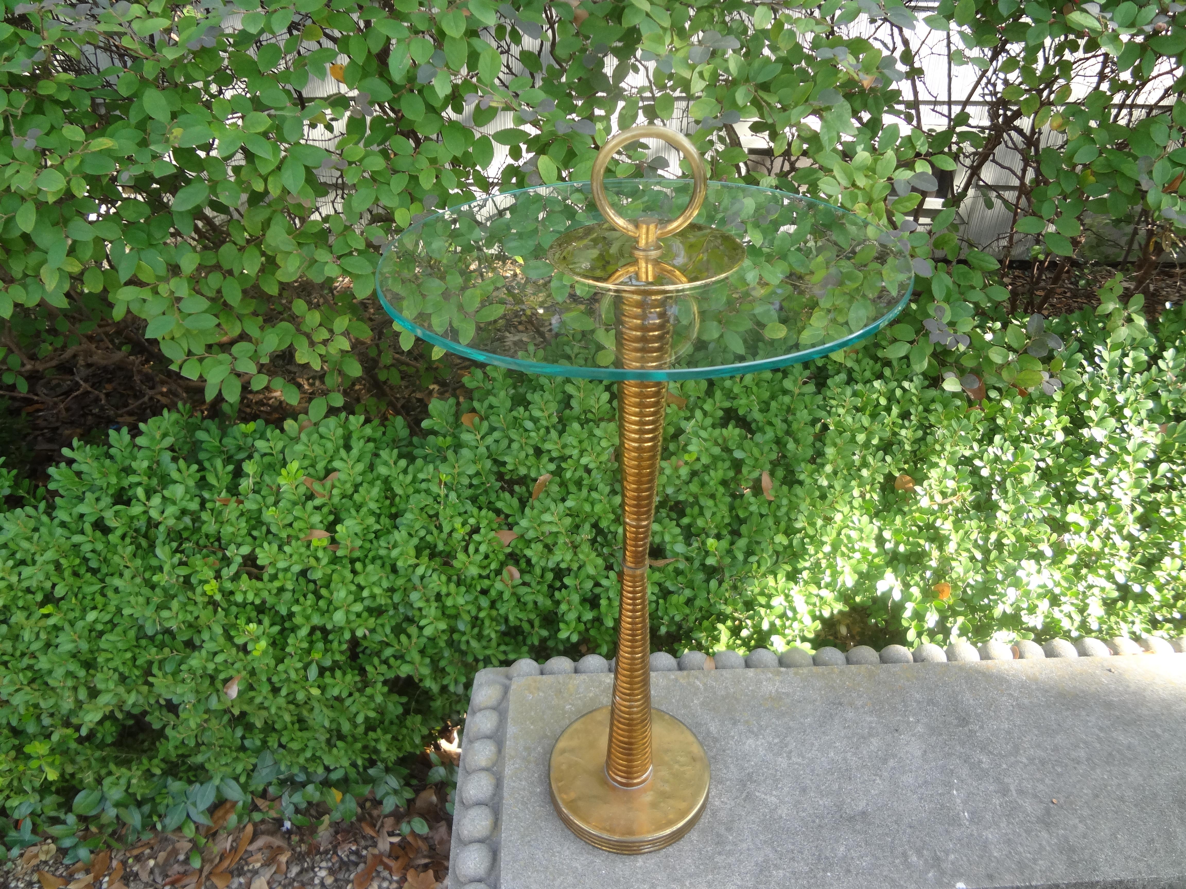 Italian Modern brass and glass side table. Our Italian Gio Ponti/Cesare Lacca style brass and glass table, also referred to as a Servo Muto has a spiral brass structure with a glass top and a brass handle. Perfect drinks table, serving table or