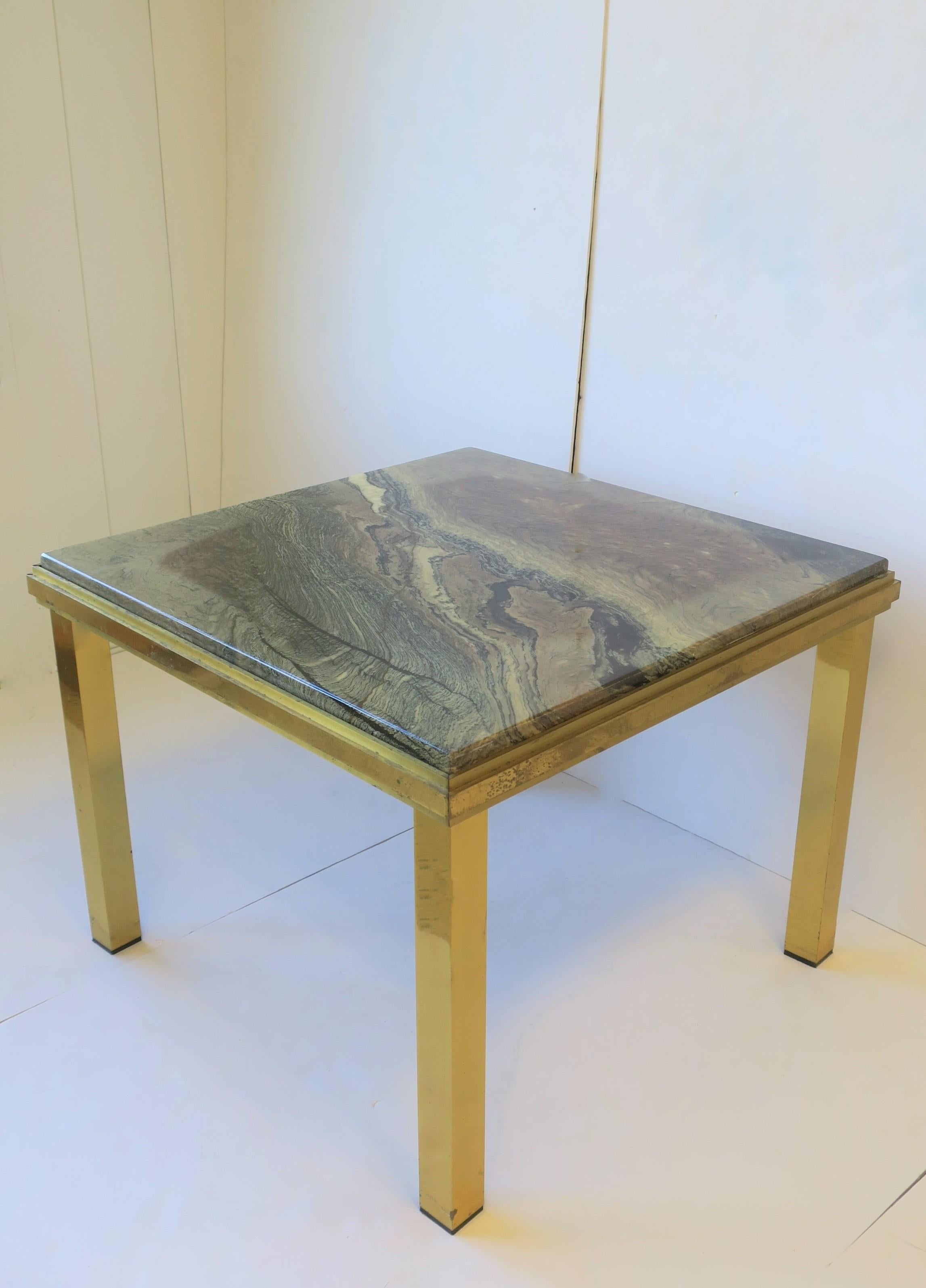 A substantial Italian '70s modern brass and marble end table, in the style of Italian designer Willy Rizzo, circa 1970s, Italy. A substantial square brass frame with a substantial partial inset neutral multicolored marble top. Marble top colors
