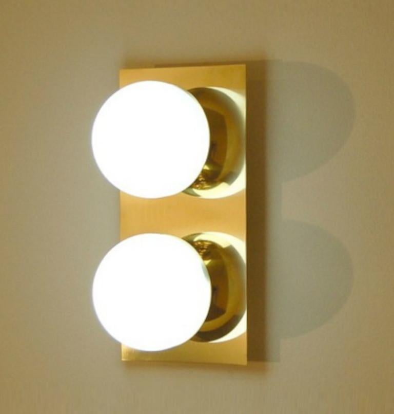 Elegant wall light or flush mount shown in polished brass with opaline milky glass globes fabricated in Italy by Fabio Ltd. 

This is a modern, contemporary interpretation of a classic wall light, strongly influenced by Italian Mid-Century Modernism