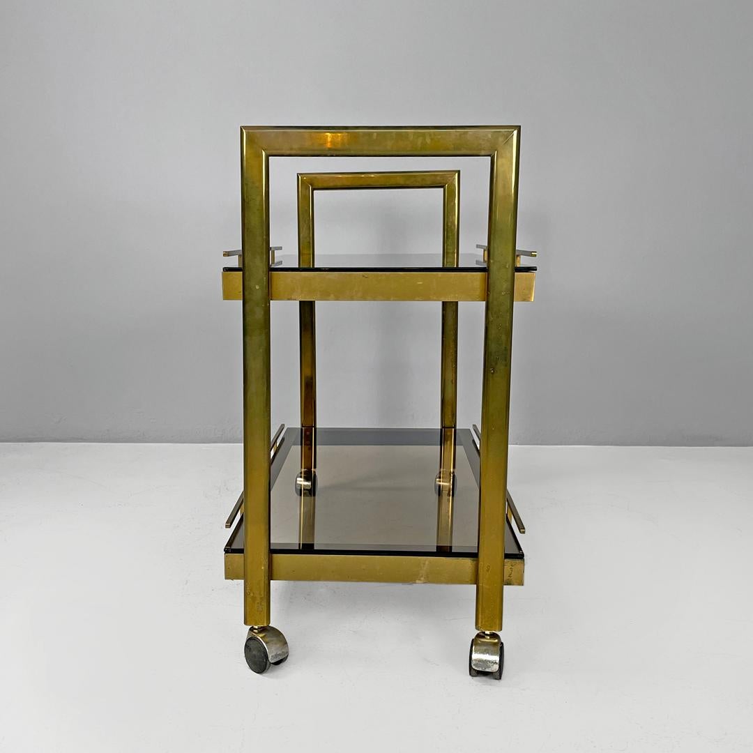 Brass Italian modern brass and smoked glass trolley with handles, 1980s For Sale