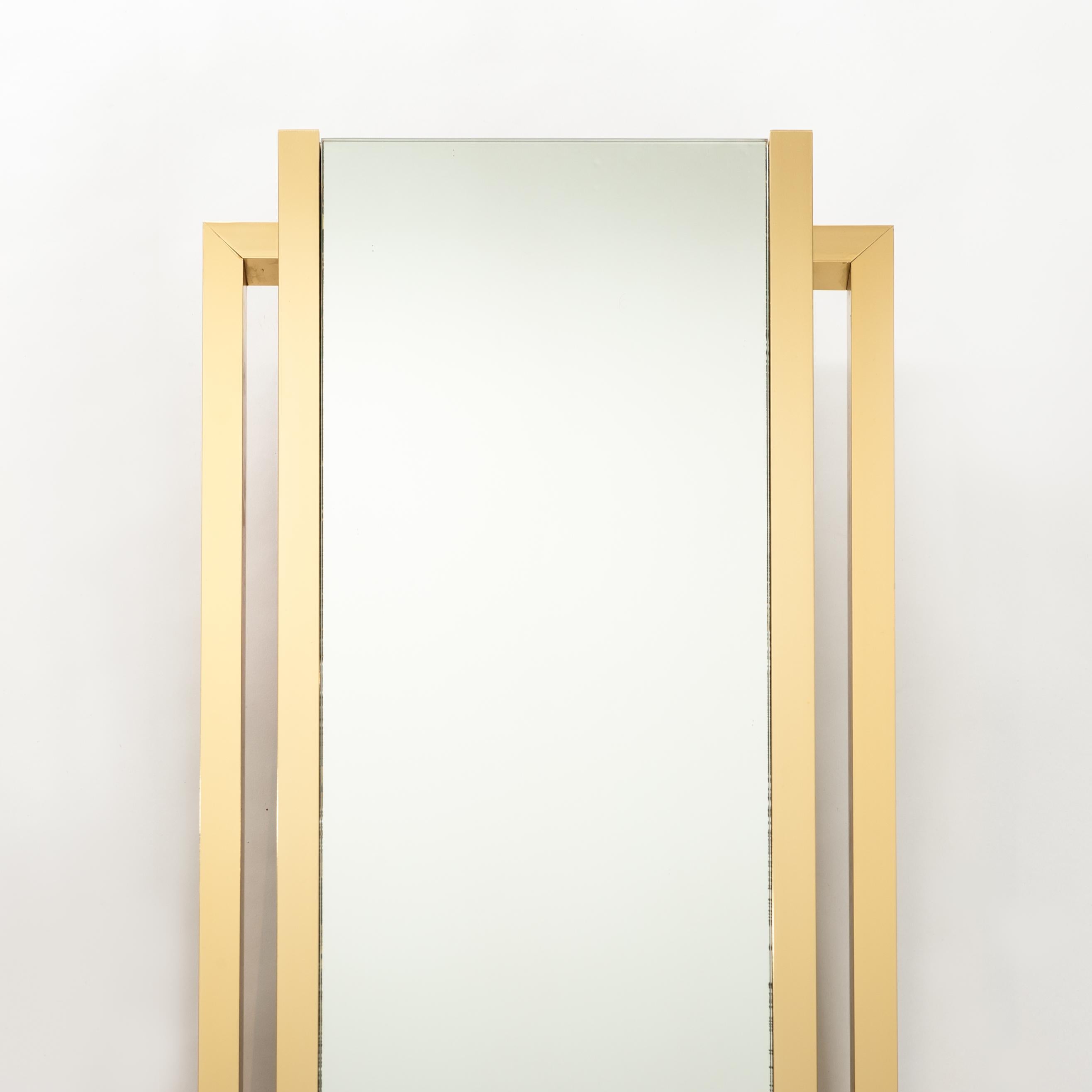 Stylish straight lined wall mirror - the construction of the stepped brass frame has a width of 3cm. 
A brass console in the same style appertains to the mirror.
  