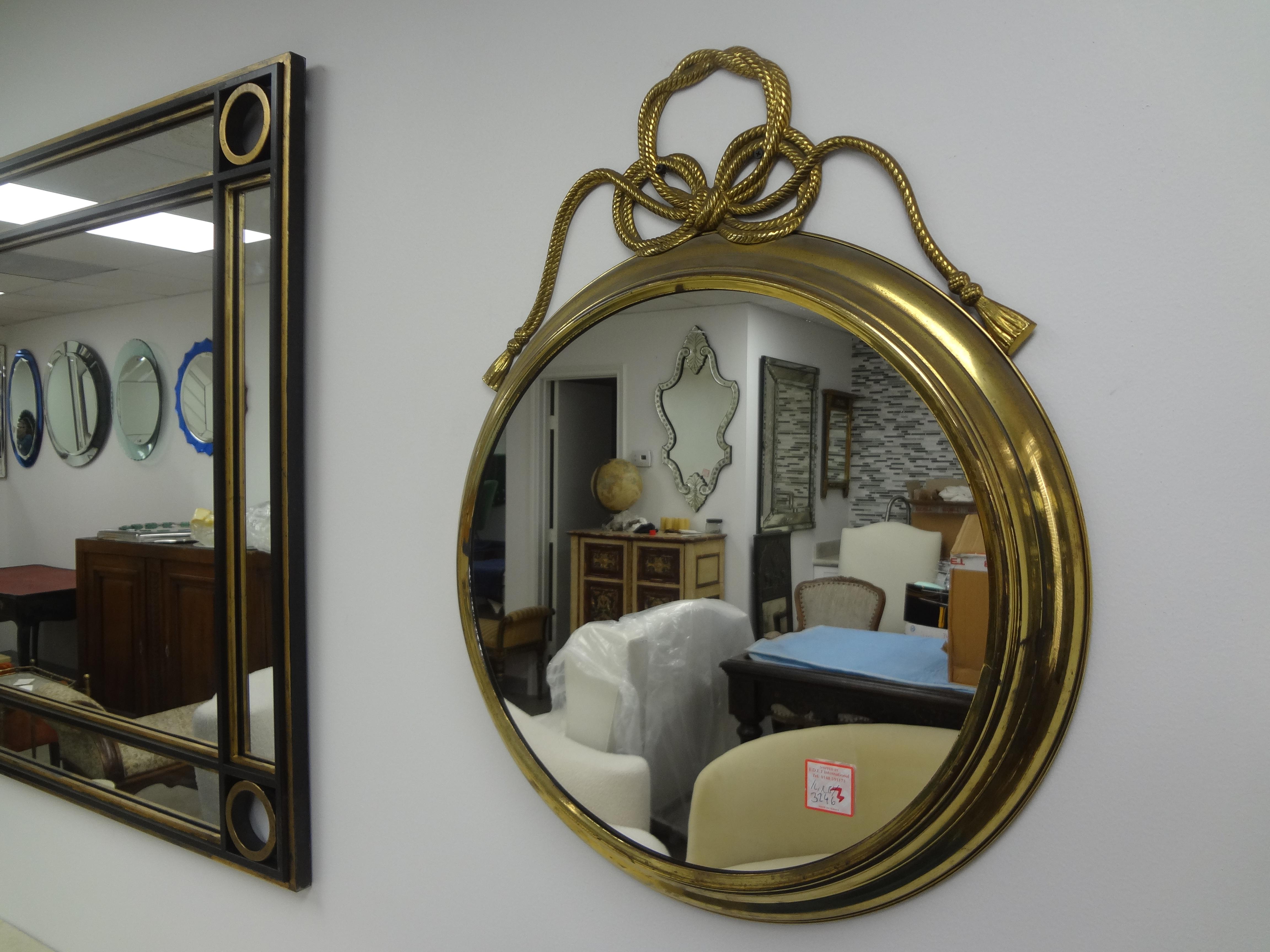 Italian Modern Brass Mirror With Bow.
Our chic Italian Hollywood Regency brass mirror is well constructed and adorned with a braded bow at the top.
Perfect in a powder room!