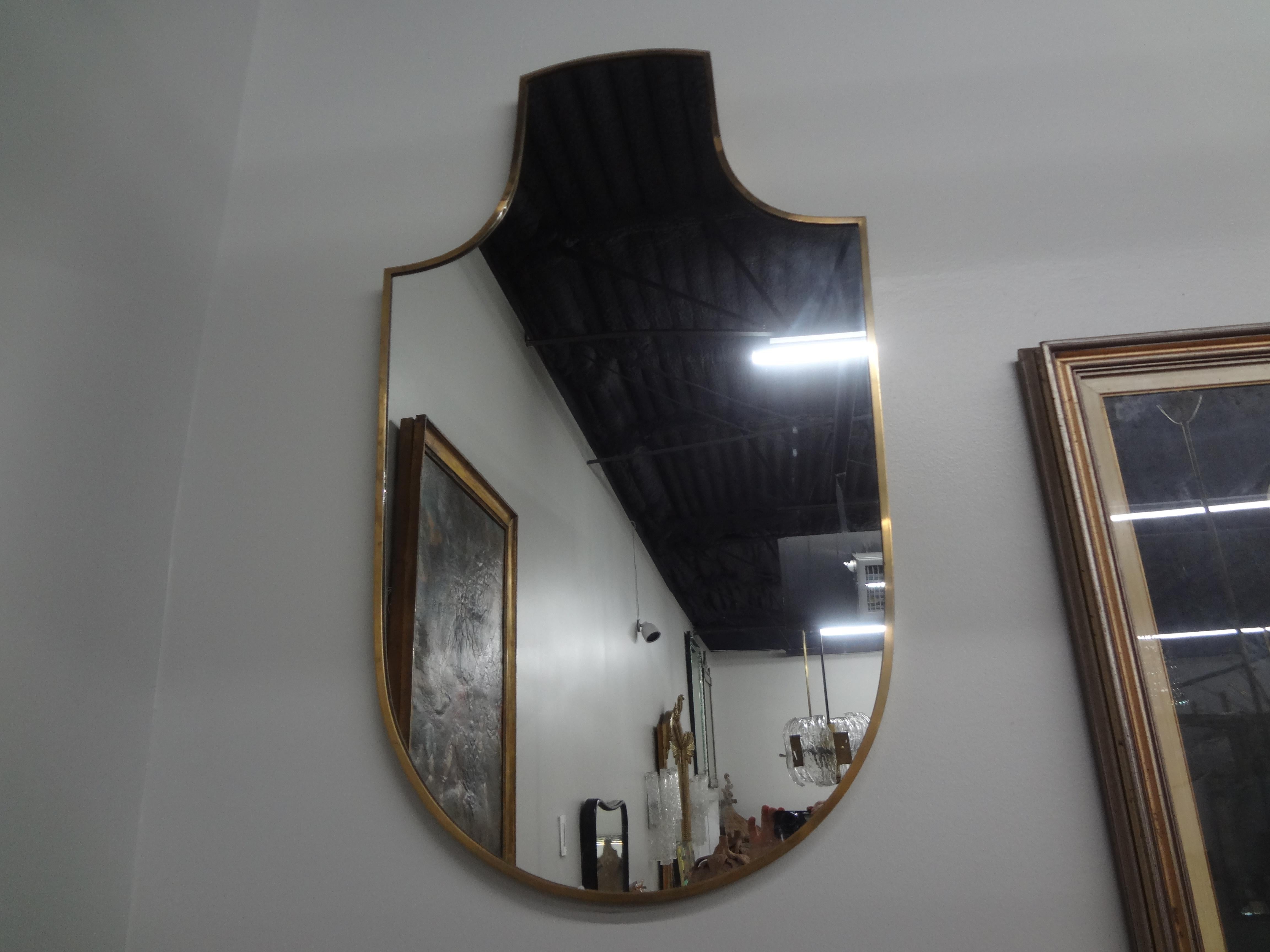 Italian Modern Brass Shield Shaped Mirror.
This versatile Italian mid century modern Gio Ponti inspired brass shield shaped mirror will work in a variety of interiors.
Perfect for a powder room, dressing room or closet.