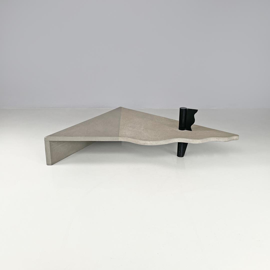 Italian modern cement and black metal wavy triangular coffee table, 1980s
Triangular coffee table. The top is made of concrete, has two straight sides and the third shaped with wavy lines. One side of the table has a leg of the same length, while