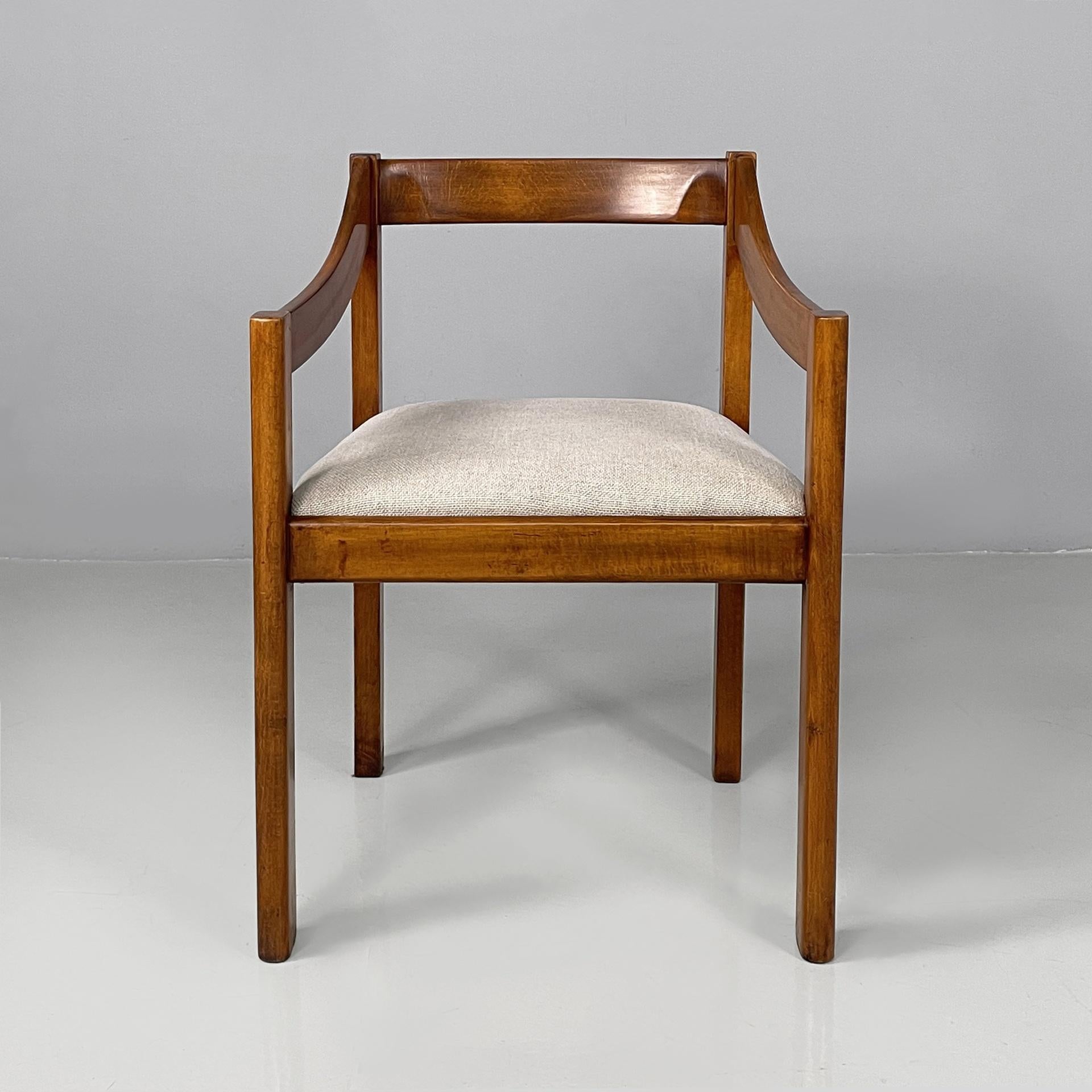 Italian modern chairs with armrest in wood and beige fabric, 1970s
Set of four vintage and fantastic  chairs with squared seat padded and covered in beige fabric. The backrest and armrests are made of wooden slats, while the legs are round