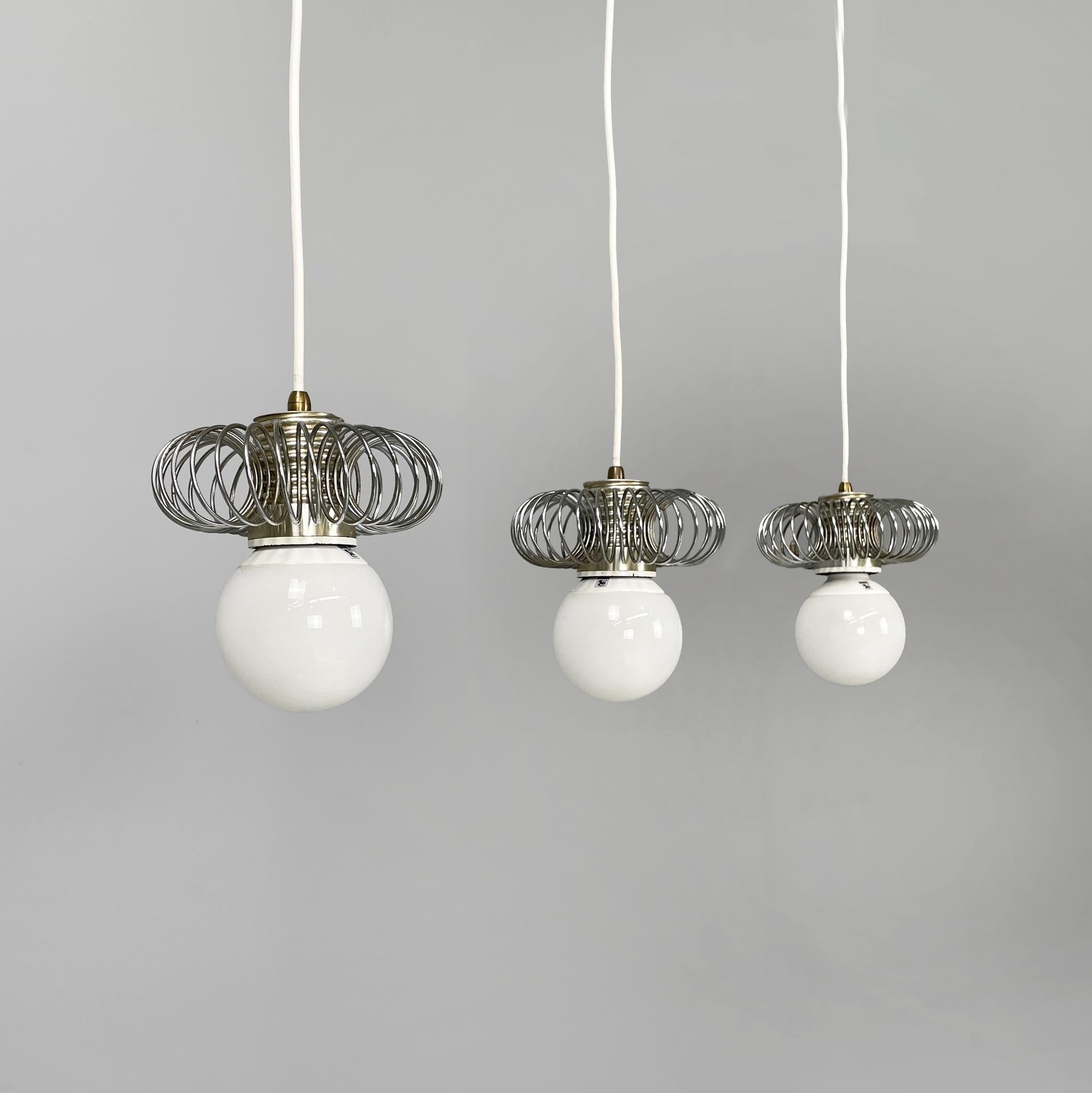 Italian modern chandeliers in metal with spiral structure, 1980s
Set of three chandeliers or ceiling lamps with metal structure. It has a metal bulb holder with a decorative spiral structure. White cable. Ceiling attachment in black painted