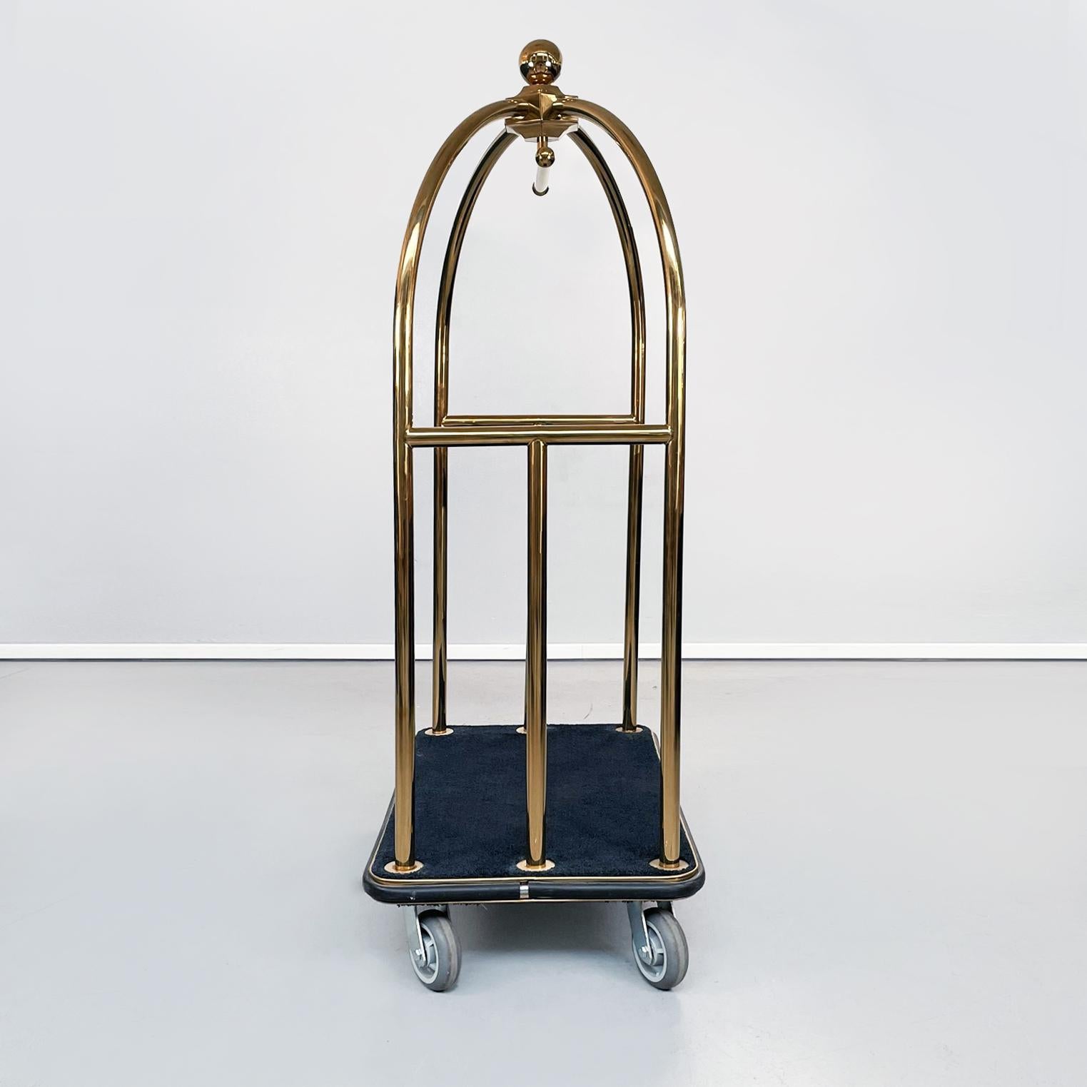 Italian modern Classic Luggage cart in golden metal and black fabric, 1990s
Luggage cart, typical for hotels, with rectangular top in black fabric. The central structure is in curved tubular metal, finished in gold. In the center it has a horizontal