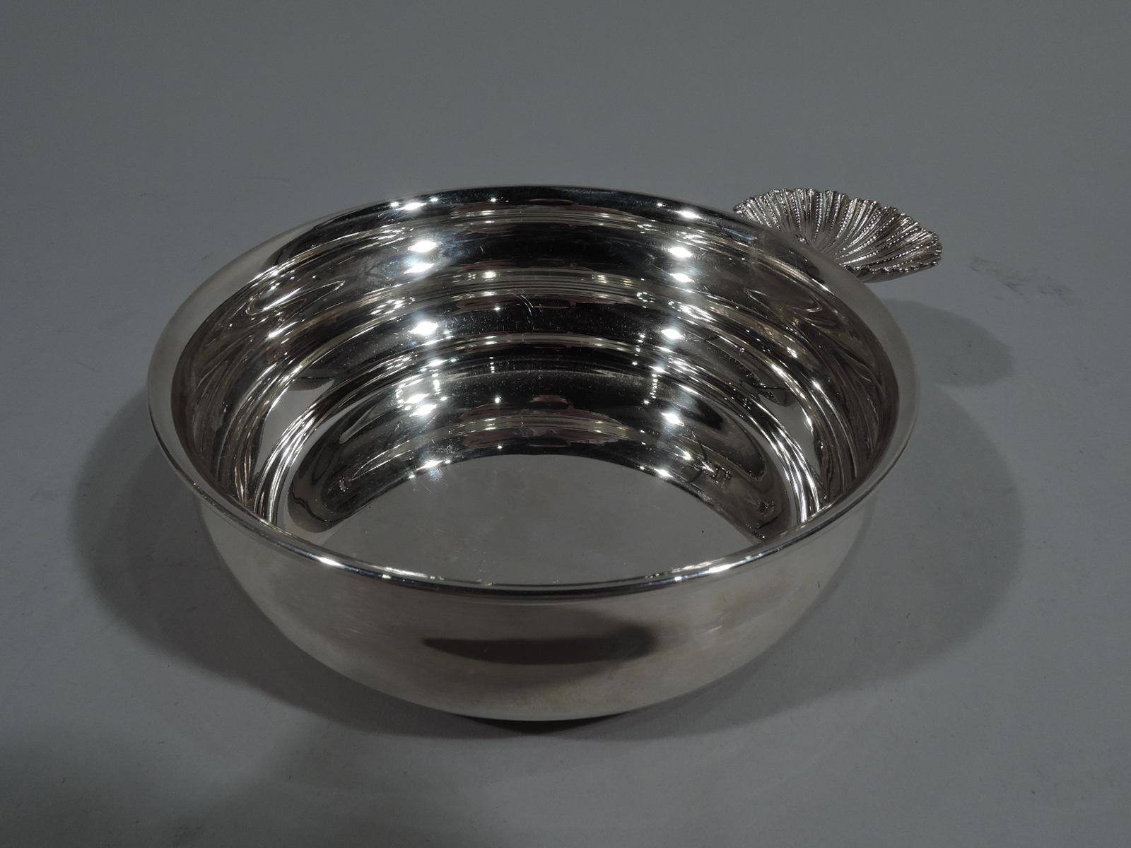 Classical sterling silver baby gift. Made by Buccellati in Milan. Round and curved bowl with inset foot and scallop shell handle. A stylish baby gift. Marked “Buccellati / Sterling”. Weight: 5 troy ounces.