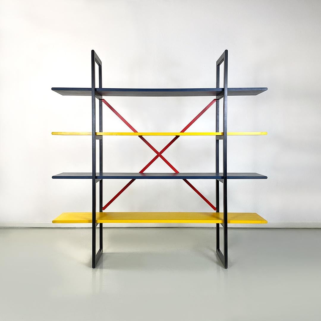 Italian modern colored solid wood self-supporting bookcase, 1980s.
Self-supporting bookcase with structure entirely in solid wood composed of two vertical uprights in black wood, with four tie rods always in red wood placed on the back, screwed to