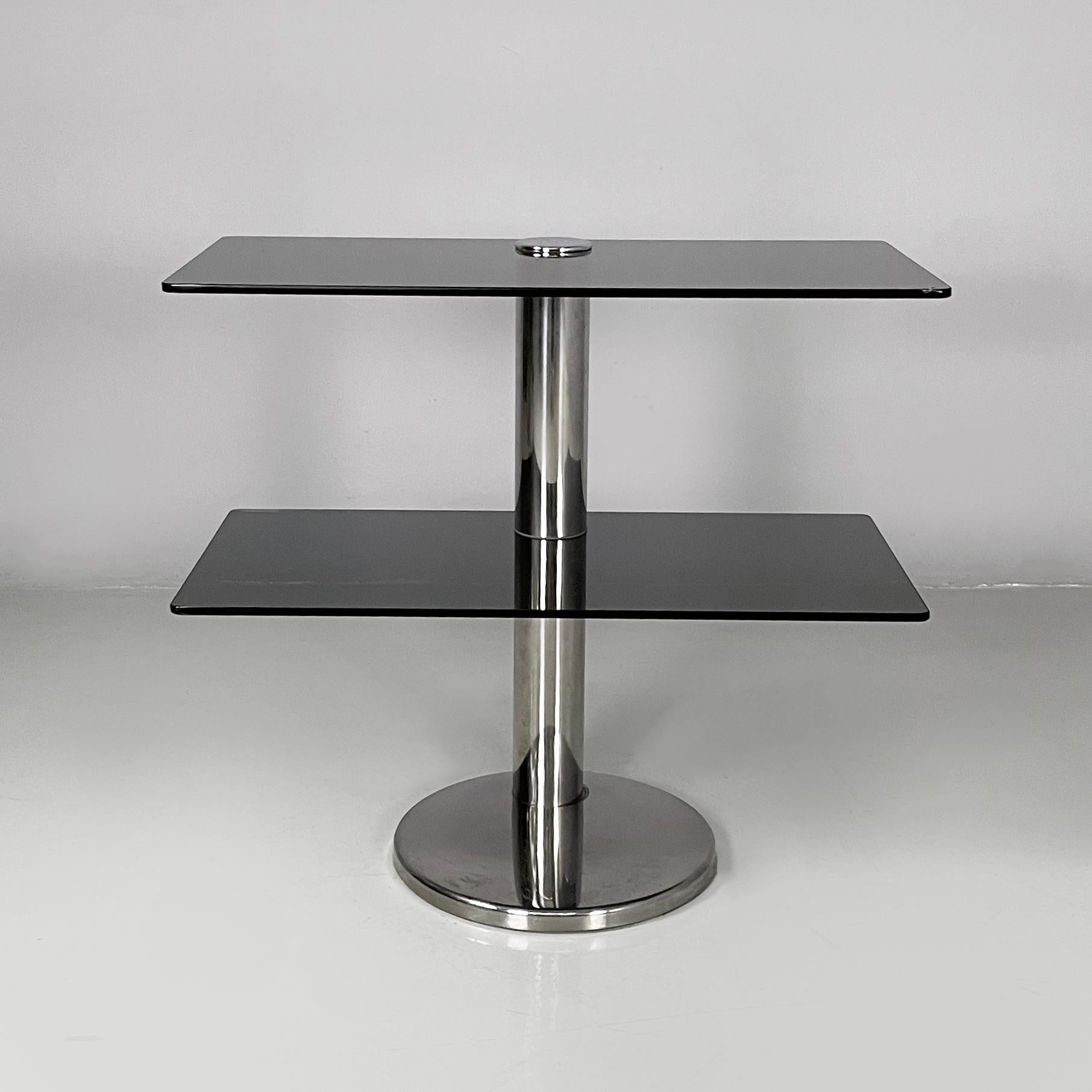 Italian modern console in smoked glass and steel, 1980s
Console table with double rectangular shelf and rounded corners in smoked glass. The central round-section structure is made of steel. Round steel base.
1980s.
Fair condition. The glass shows