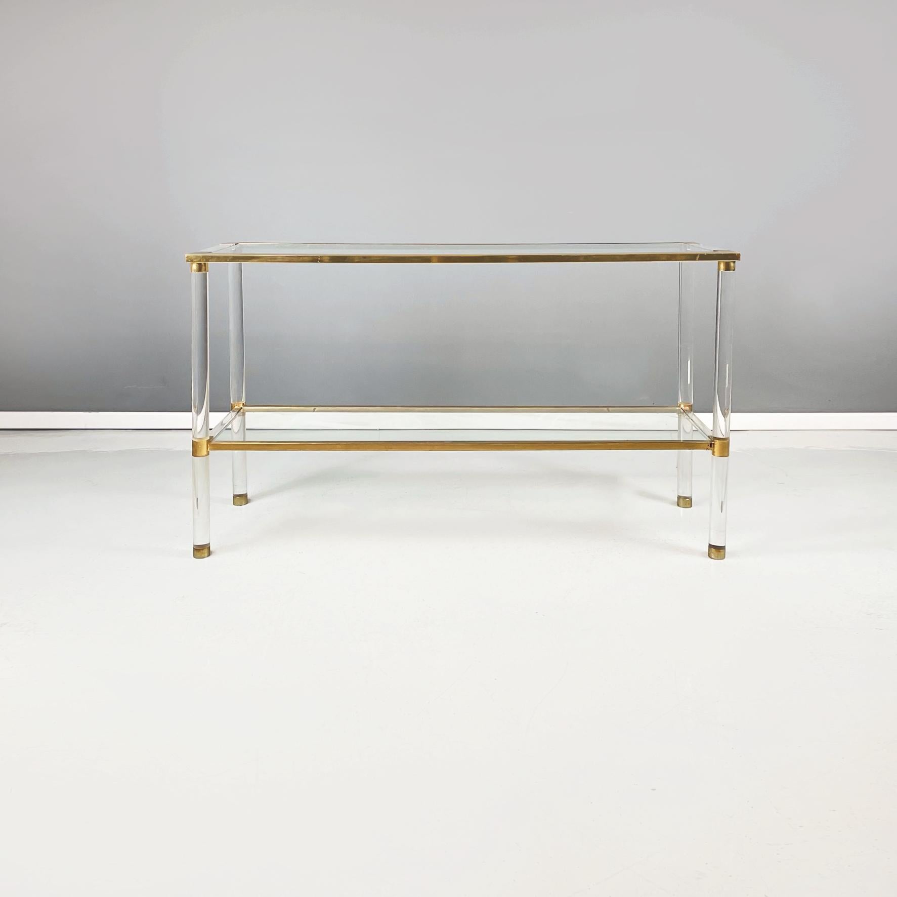 Italian modern console with 2 shelfs in plexiglass, glass and brass, 1970s.
Console with double rectangular shelf in plexiglass, glass and brass. The two glass shelfs are supported by a brass structure with transparent plexiglass parts. The round