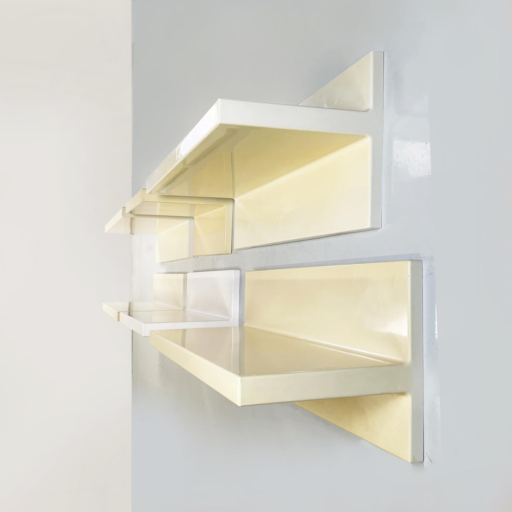 Italian modern cream white plastic shelves by Marcello Siard for Kartell, 1970s. 
Set of six shelves with asymmetrical profile in plastic in colors ranging from white to cream, as the surface has taken on light in an uneven way over the years. They