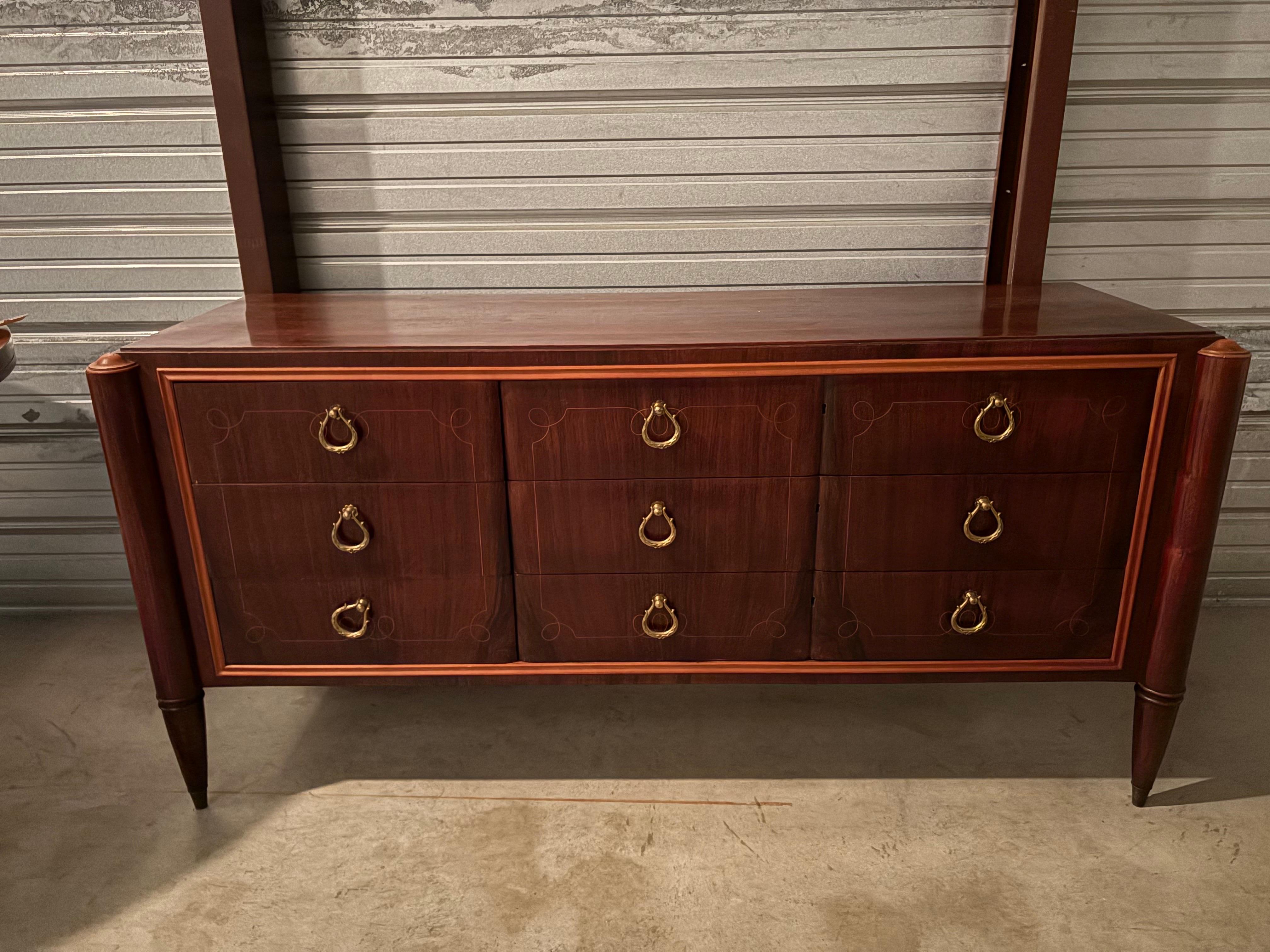 Italian Modern Credenza By Paolo Buffa.
Offered is a handsome Italian mid century credenza, commode, chest or sideboard with beautiful lines, tapered legs and bronze hardware.
This versatile piece could be used in an entrance hall, dining room,