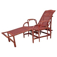Used Italian modern dark red rattan armchair 981 with footrest by Bonacina, 1980s