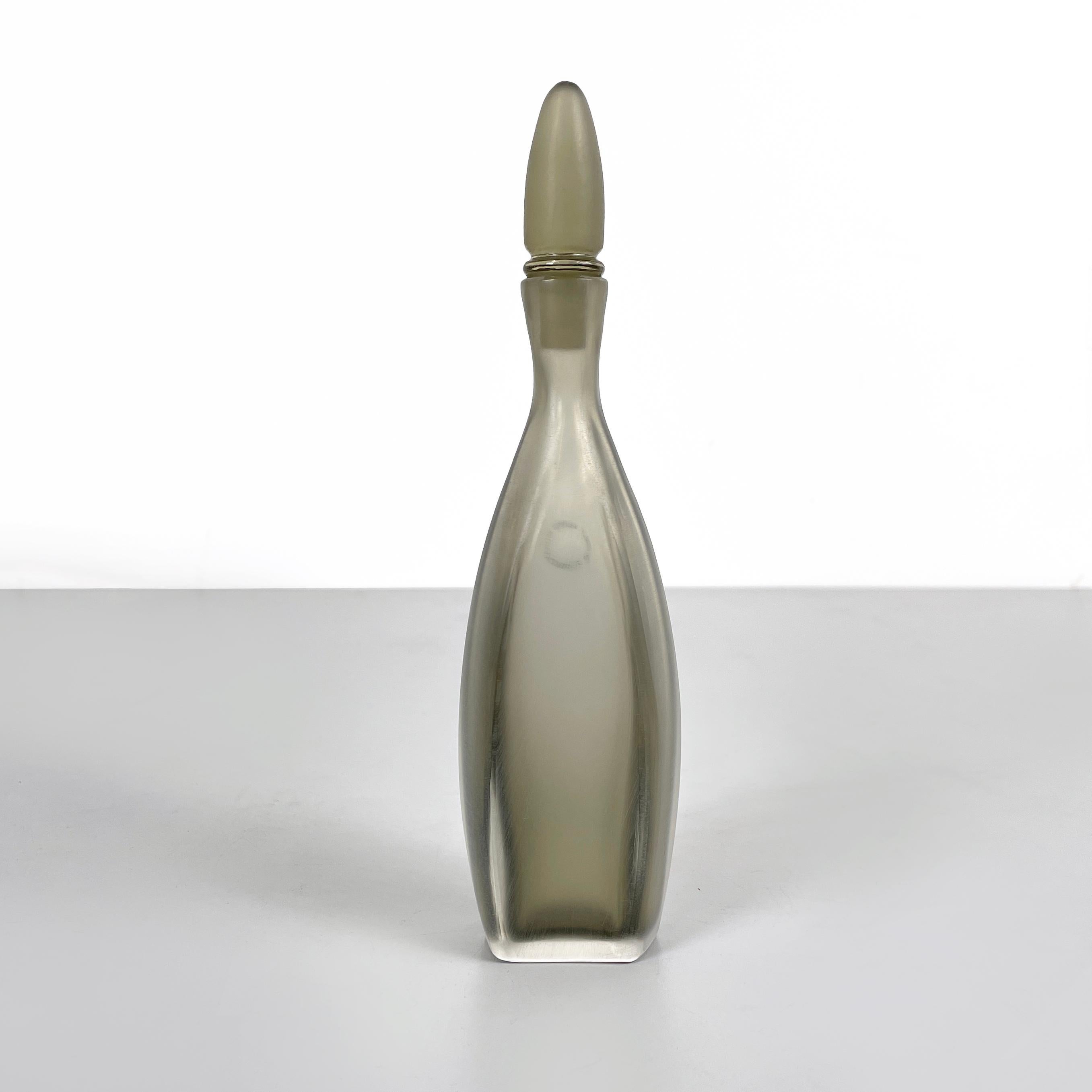 Italian modern Decorative bottle with cap in gray Murano glass by Venini, 1990s
Decorative bottle with a square base, in matt gray and transparent Murano glass. The round-based cap has a tapered and elongated shape. The bottle tends to widen in the