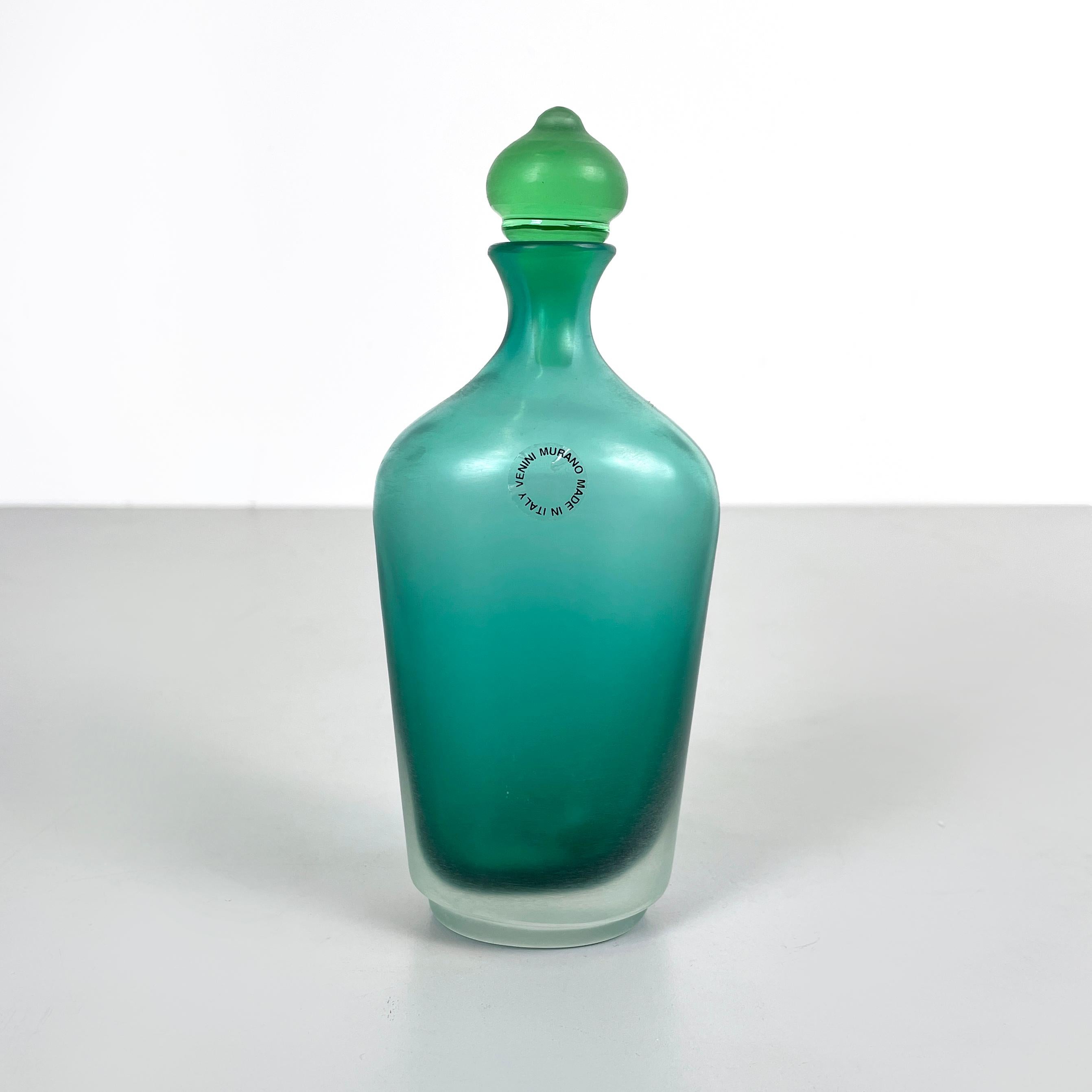 Italian modern Decorative bottle with cap in green Murano glass by Venini, 1990s
Decorative bottle with a oval base in bright forest green and transparent matt Murano glass. The round-based cap features a tapered shape and a slightly lighter tone of