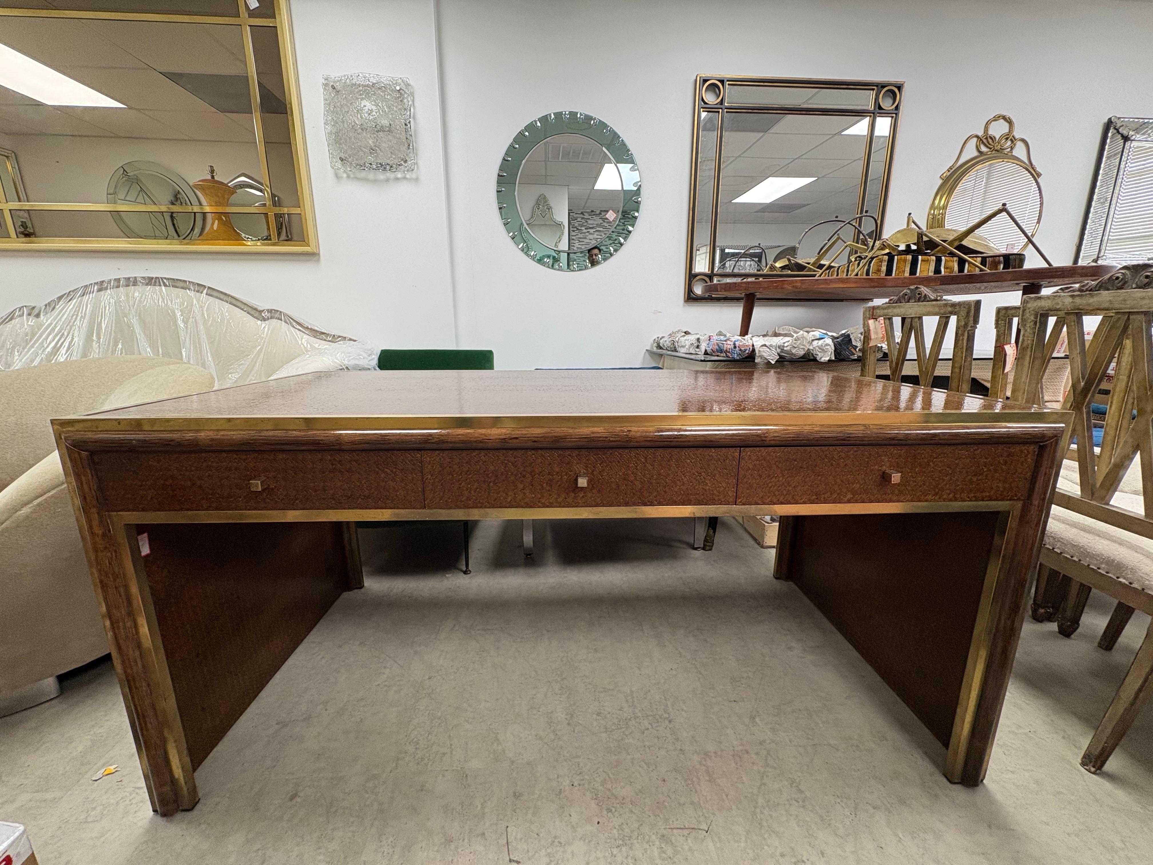 Italian Modern Desk Designed By Sandro Petti.
Offered is an large handsome desk with brass trim and three drawers designed by Sandro Petti in the 1970's. 
This stunning desk is finished on all sides and is the perfect candidate for floating in a