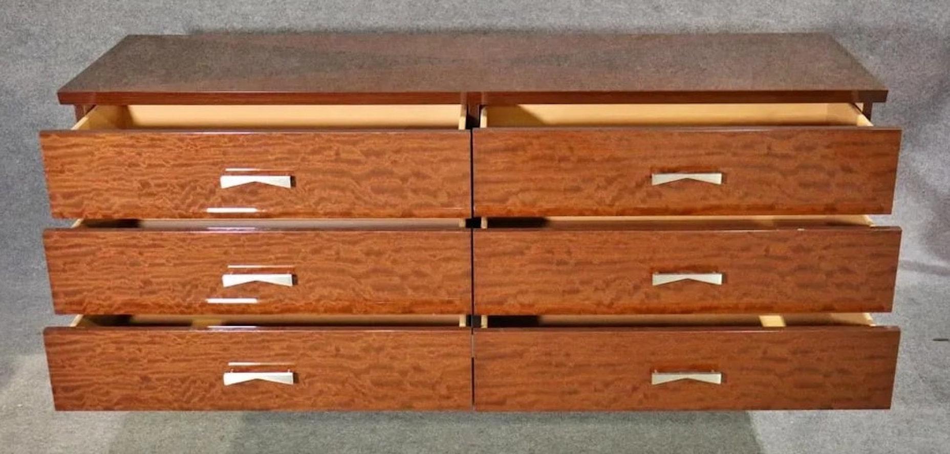 Stunning chest of drawers in wild grain wood. Sharp modern lines from the opposing grain patterned X top, to the X shaped metal base. Six wide drawers with bow-tie metal handles. Great design throughout.
Please confirm location NY or NJ.