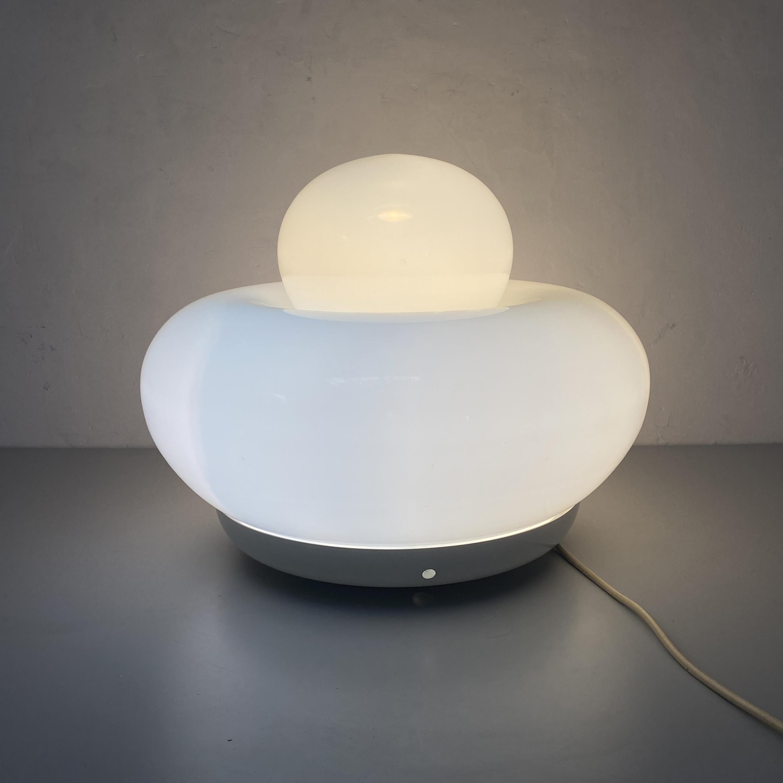 Electra table lamp by Giuliana Gramigna for Artemide, 1968
Glass table lamp with large round base in white glass and a smaller rounded top.
This table lamp was designed by Giuliana Gramigna and was produced by Artemide in Italy in 1968.

Good