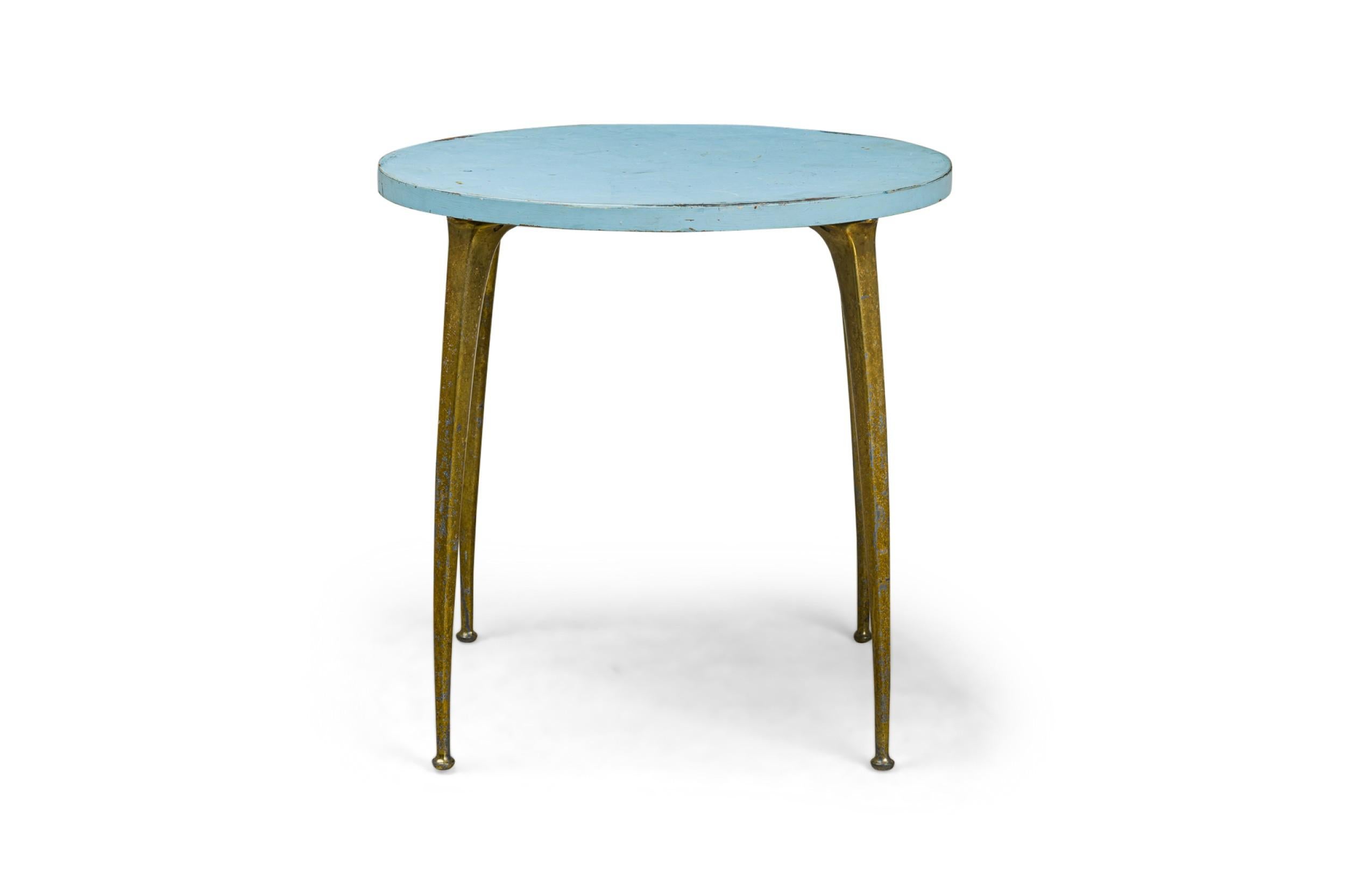 Tavolo da centro/colazione italiano del Mid-Century Modern con piano circolare in legno smaltato blu cielo, appoggiato su quattro scultoree gambe in ottone che si assottigliano verso il basso (nello stile di Gio Ponti).

Usura da finitura.
