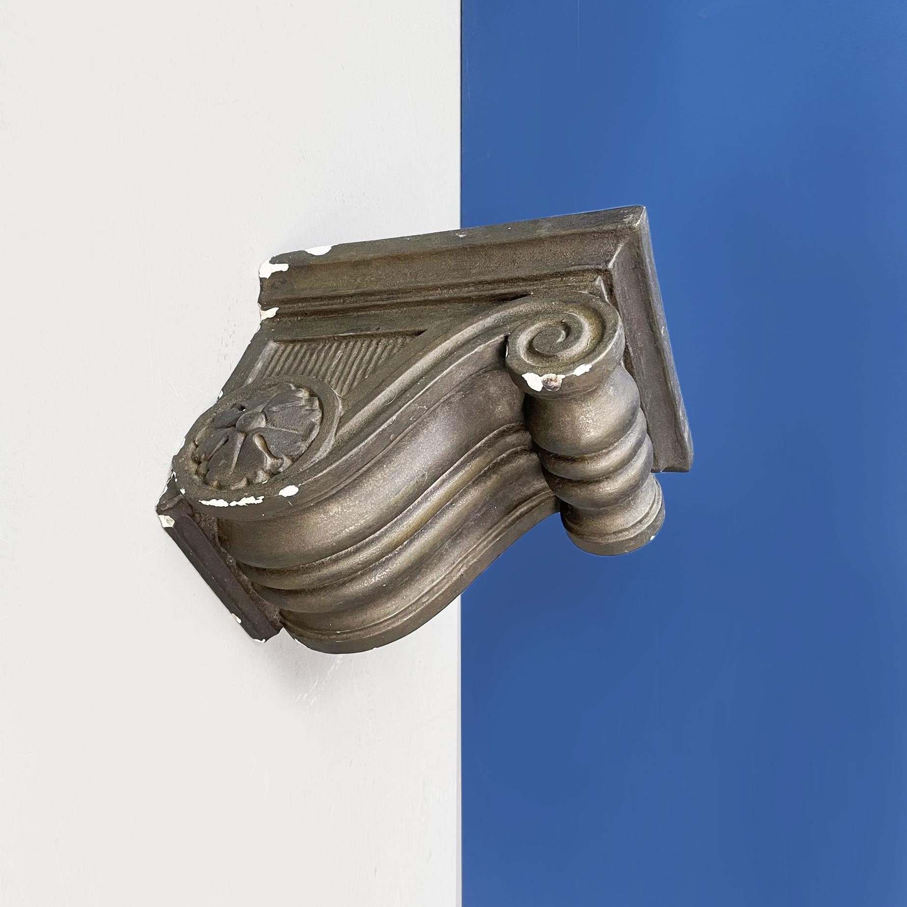 Italian modern finely worked capital in grey plaster, 1990s
Finely worked capital with curls and floral patters, in gray painted plaster. It can be used as a shelf bracket. 
1990s
Good conditions, it has some lacks.
Measurements in cm 20 x 25 x
