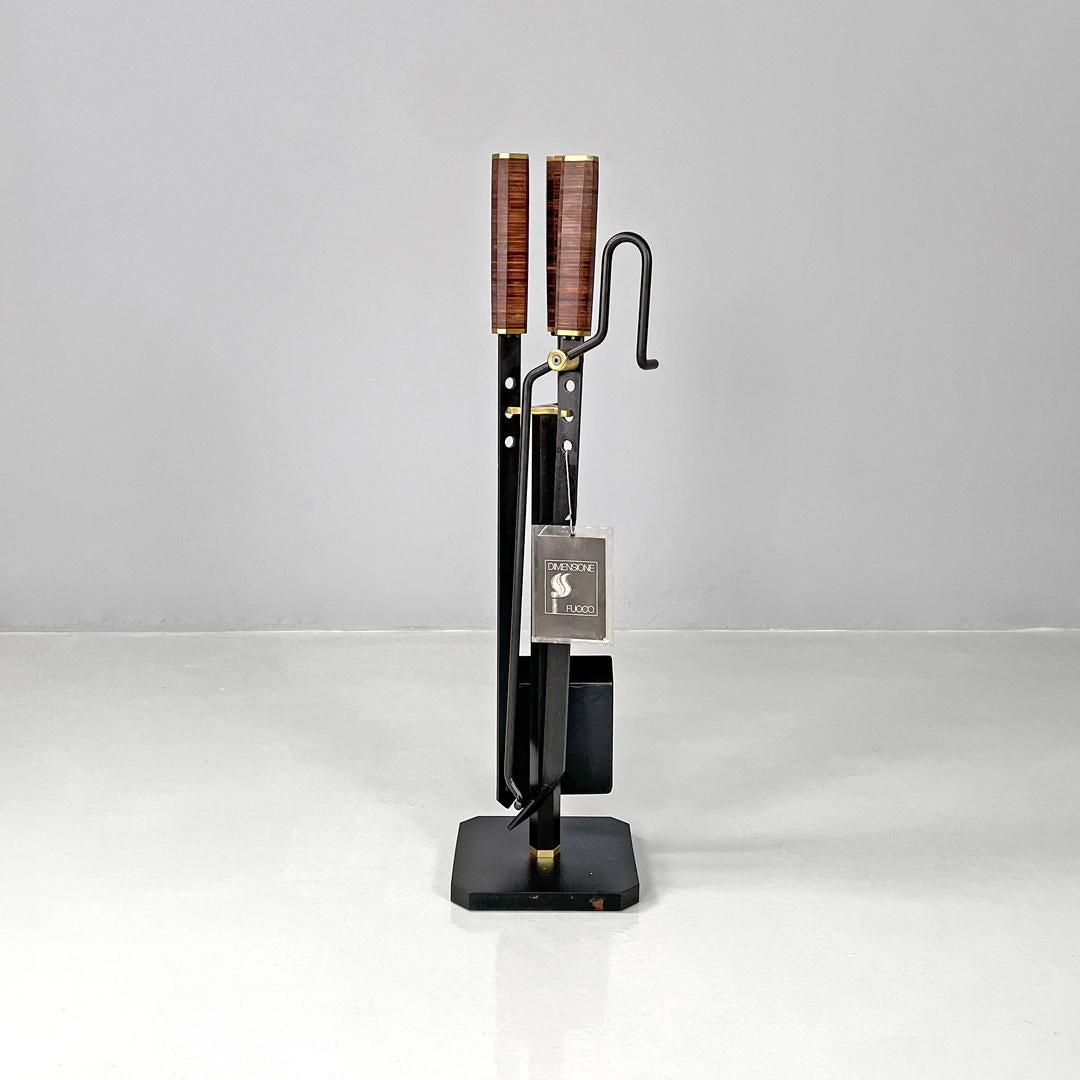 Italian modern fireplace kit Afra and Tobia Scarpa for Dimensione Fuoco, 1970s
Set of accessories and fireplace tools in black painted steel. The three tools have a wooden handle with brass details, with three holes each to attach them to the main
