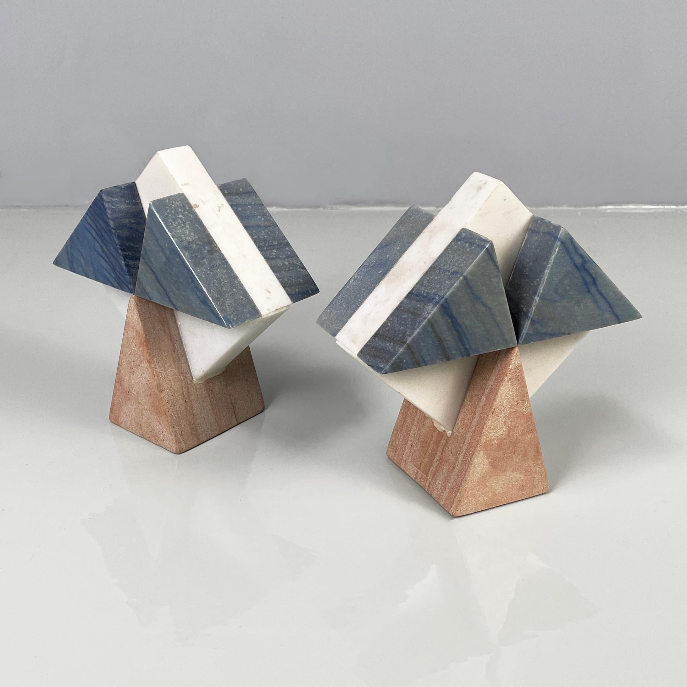 Italian modern geometric sculptures in white, blue and pink marble, 1980s
Pair of geometric marble sculptures. The structure is composed of a rhombus in white marble, on which are placed two triangles per side in blue marble. The base on which the