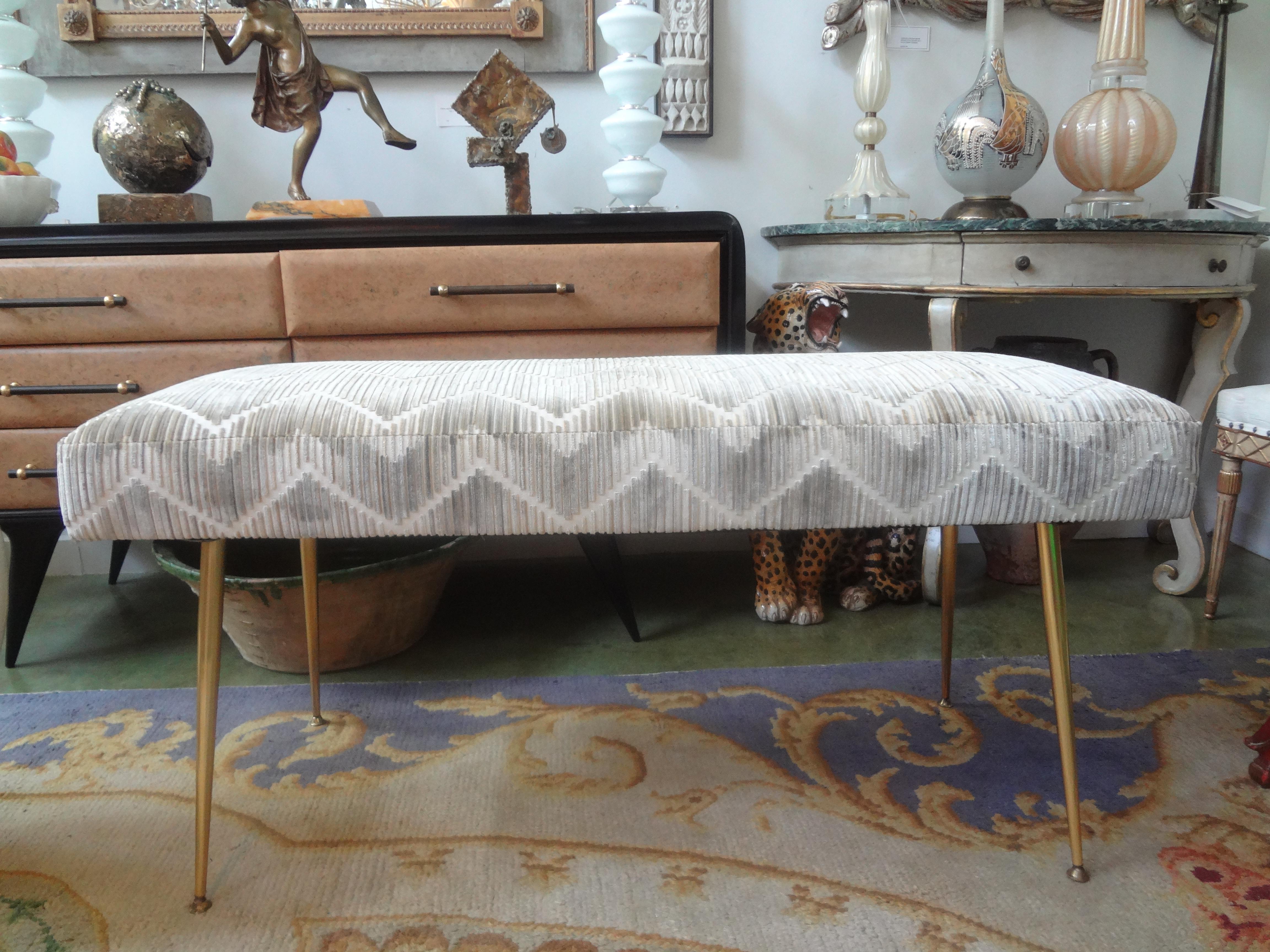 Italian Modern Gio Ponti inspired brass bench.
Stunning Italian Modern Gio Ponti inspired brass bench with splayed legs. This gorgeous Italian Mid-Century Modern brass bench has been professionally upholstered in a neutral cut velvet chevron