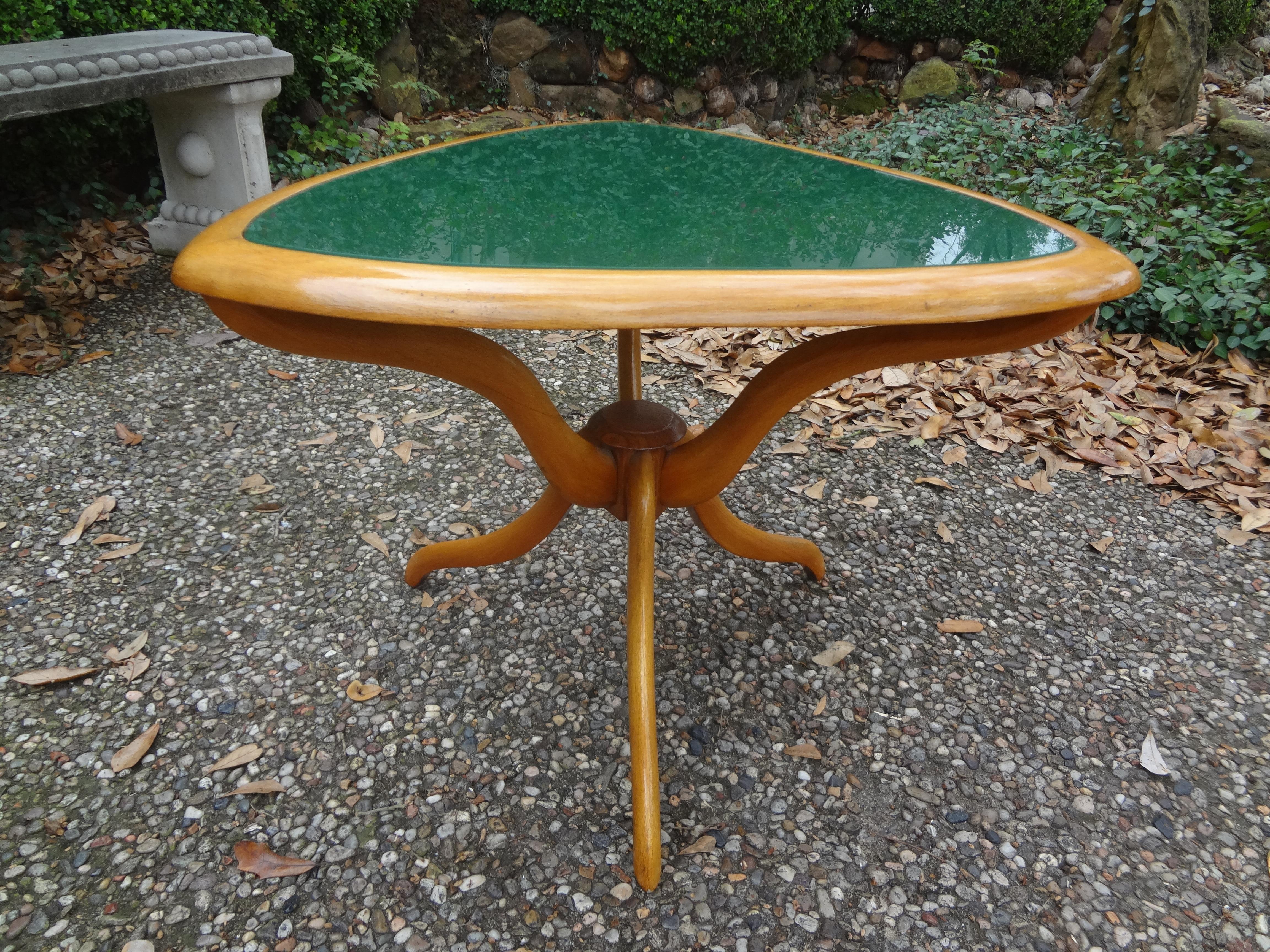 Italian modern Gio Ponti inspired table.
Stunning Italian modern Gio Ponti inspired table. This shapely Italian table was executed in sycamore with great lines and an unusual green glass top. Fantastic side table, gueridon, drinks table or cocktail